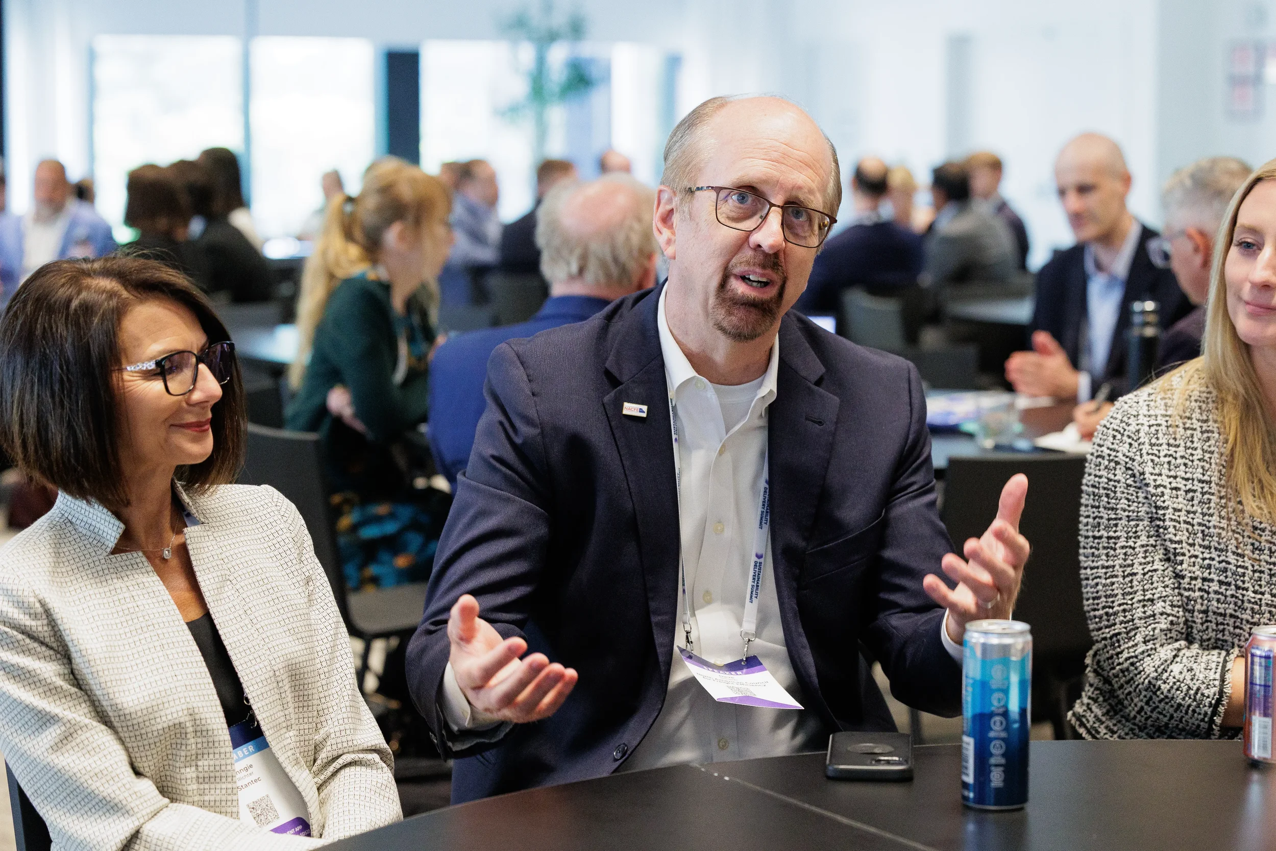 Attendees converse together during networking reception at Orlando industry conference