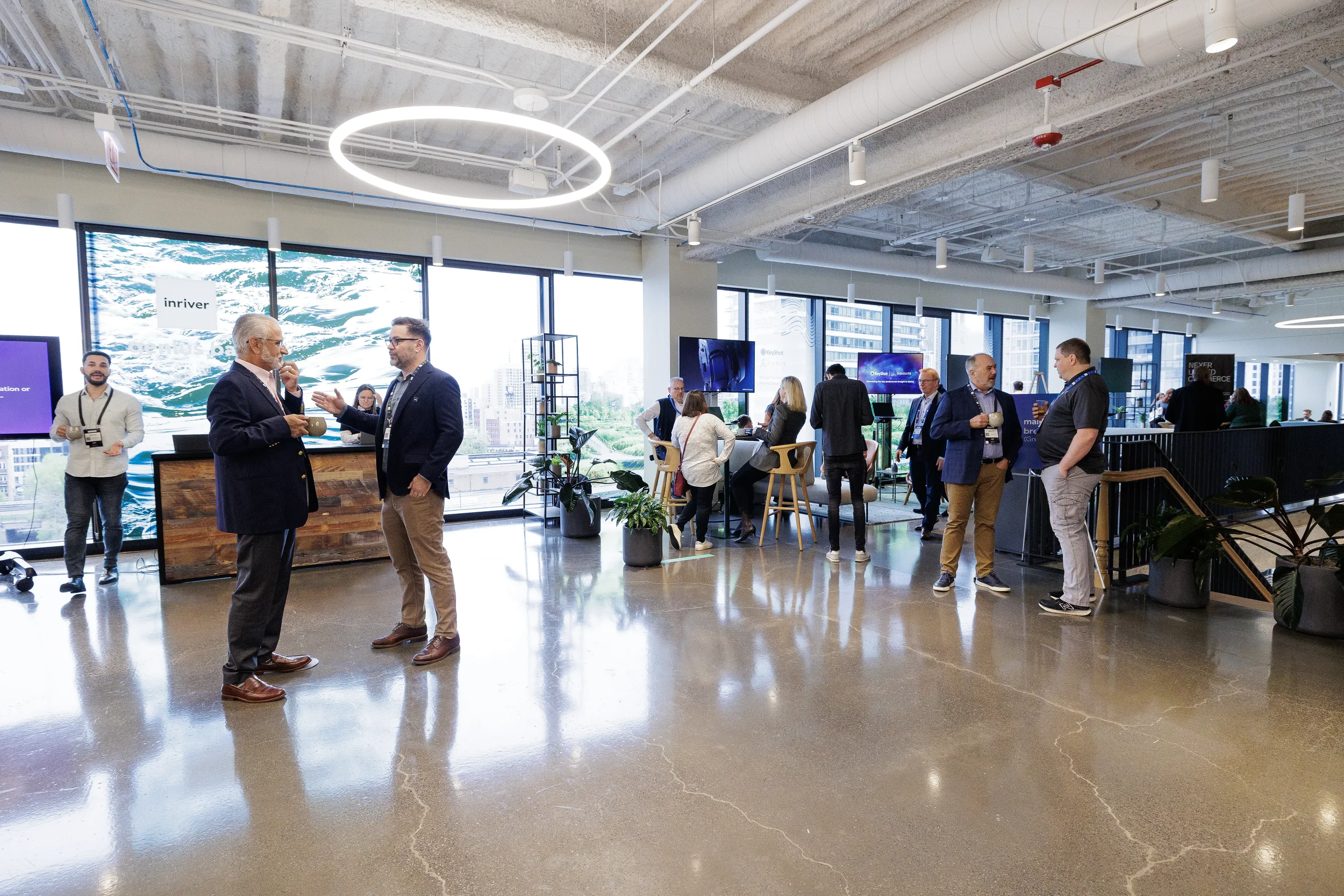 Attendees network over coffee in modern open-plan lounge at Chicago corporate event