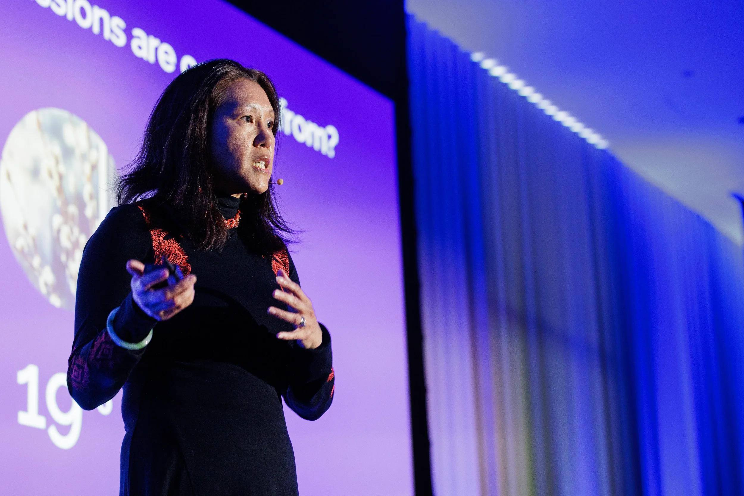 Close-up of speaker with headset microphone gesturing while presenting at Chicago corporate conference