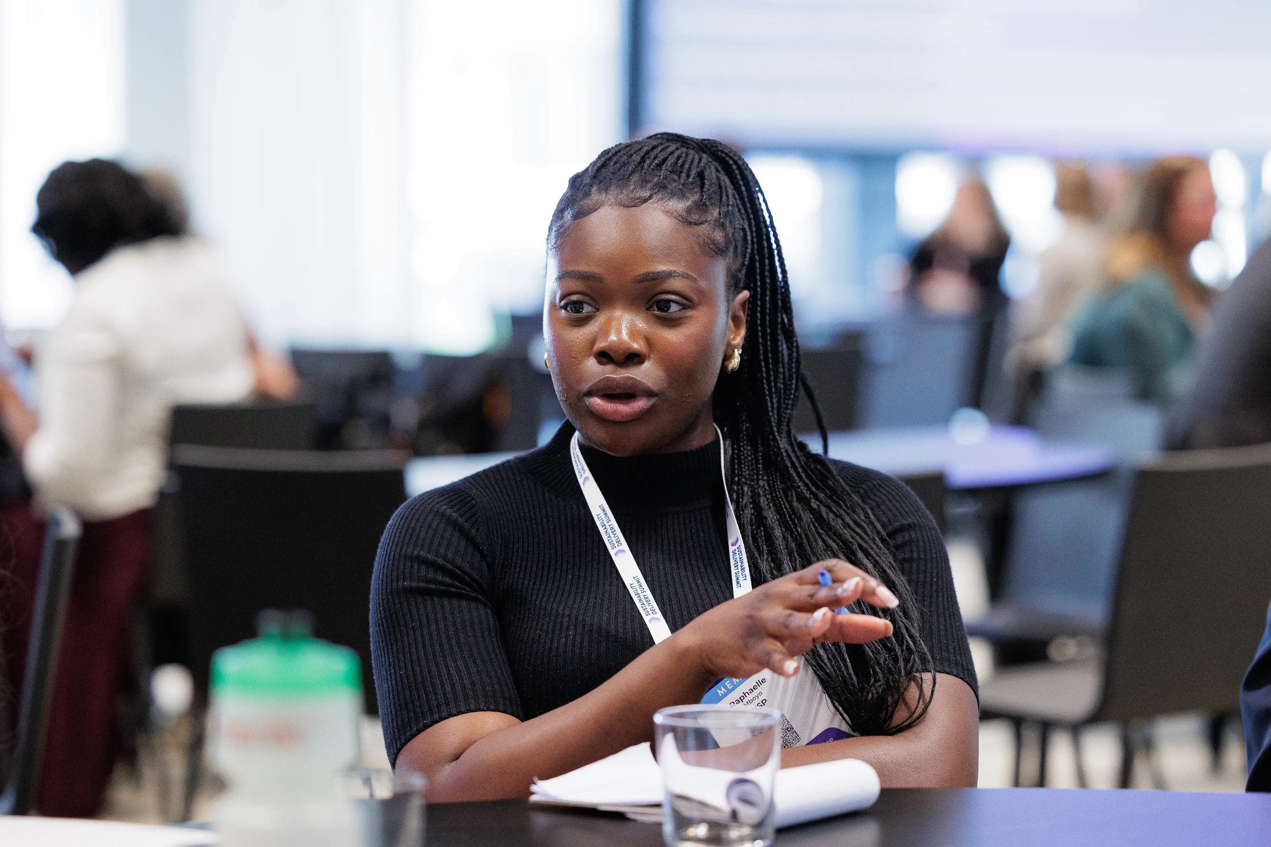 Attendee gestures while speaking during seated conversation at Orlando corporate conference