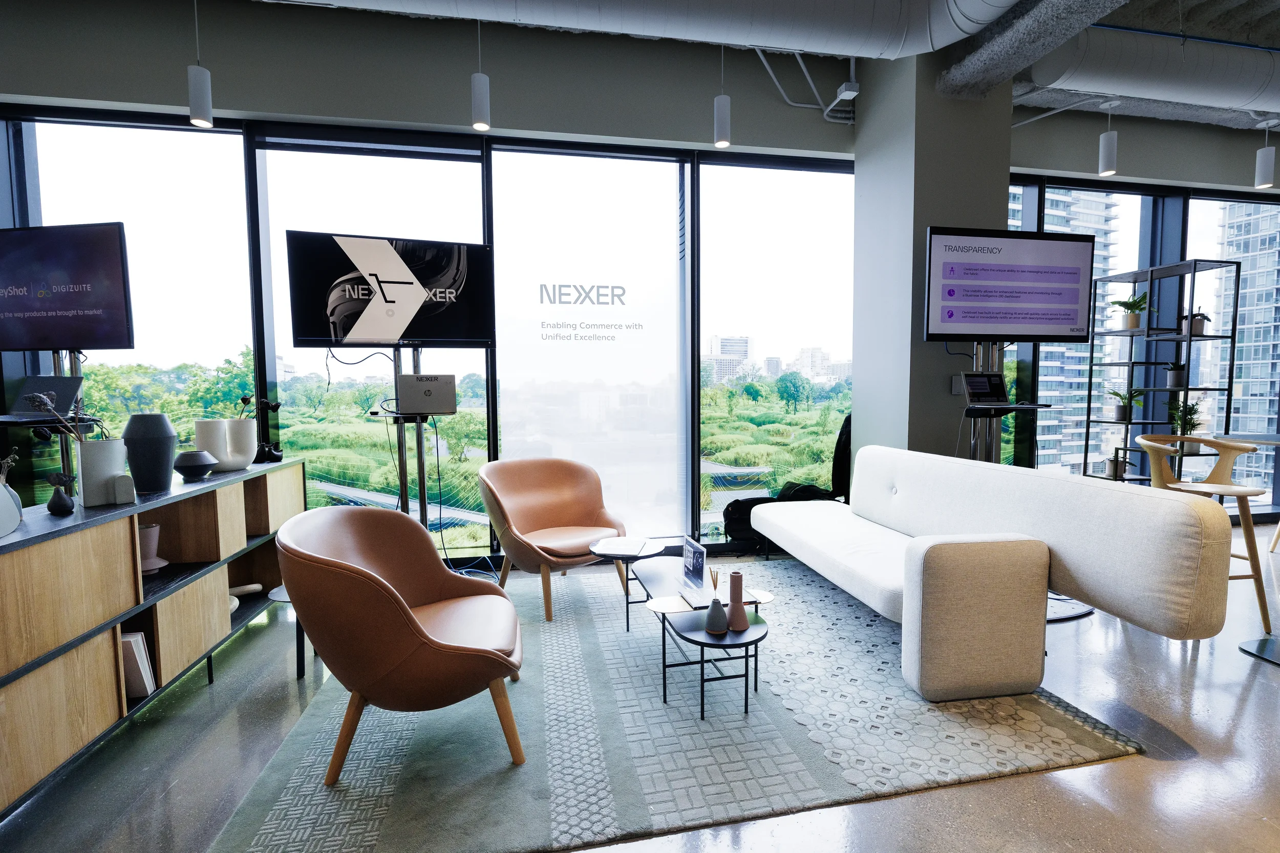 Exhibitor lounge with leather armchairs, sofa and park view at Orlando corporate conference