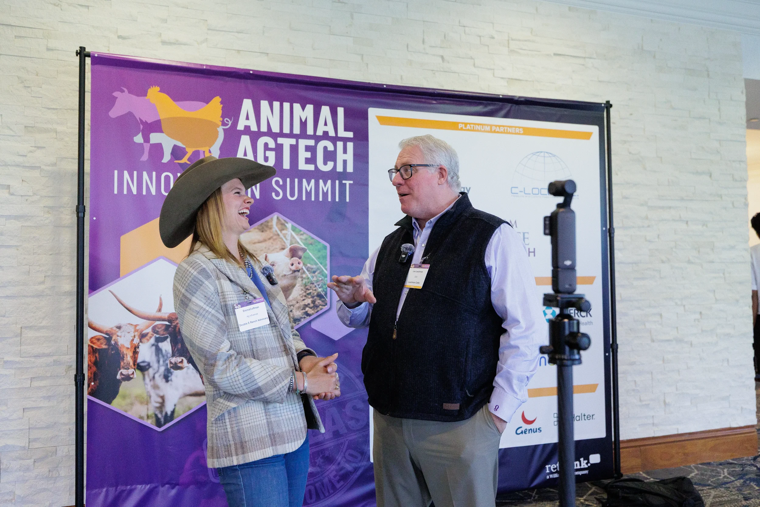Attendee wearing cowboy hat laughs during on-camera interview at Chicago industry summit