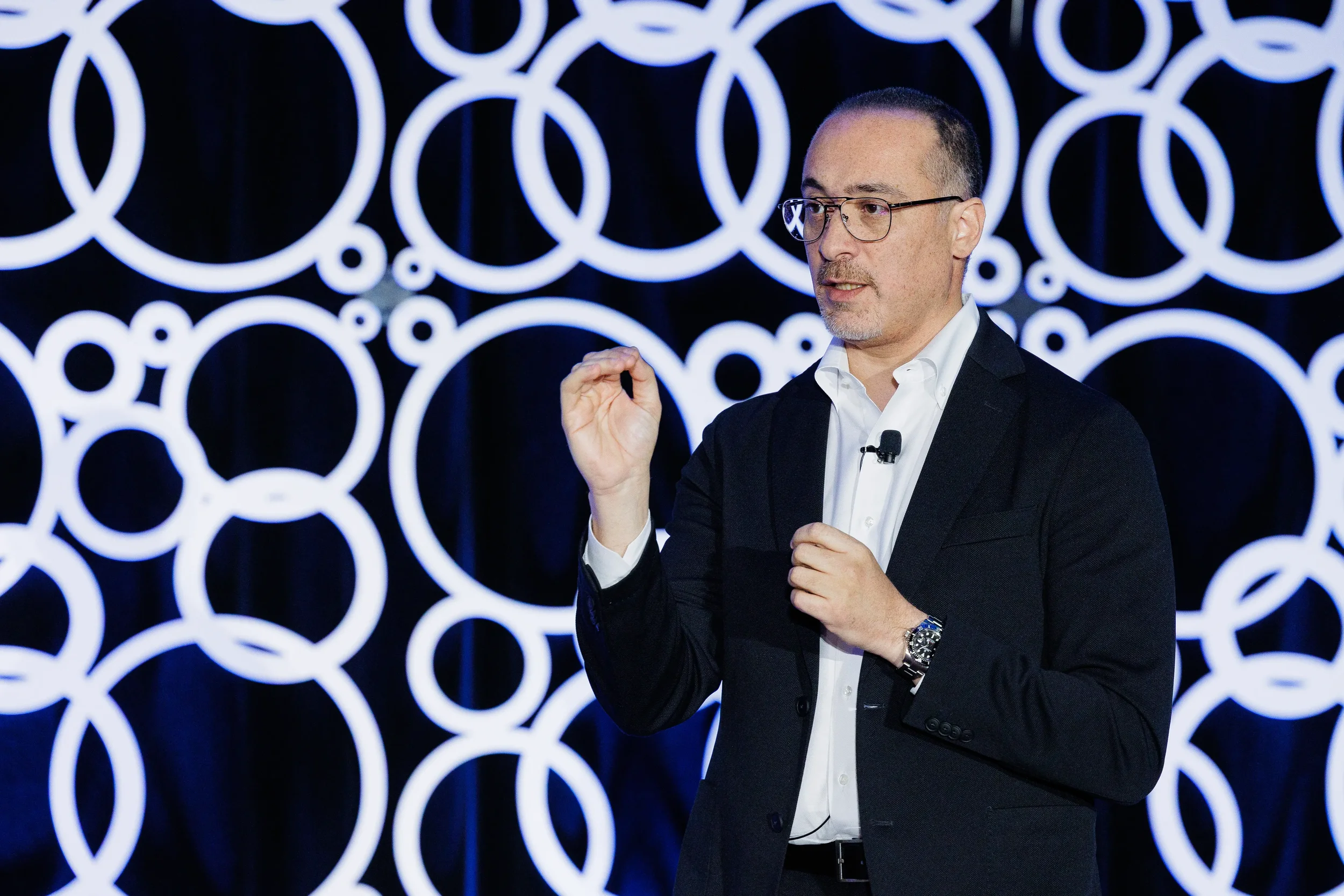 Speaker gestures while presenting on branded stage at Chicago corporate conference