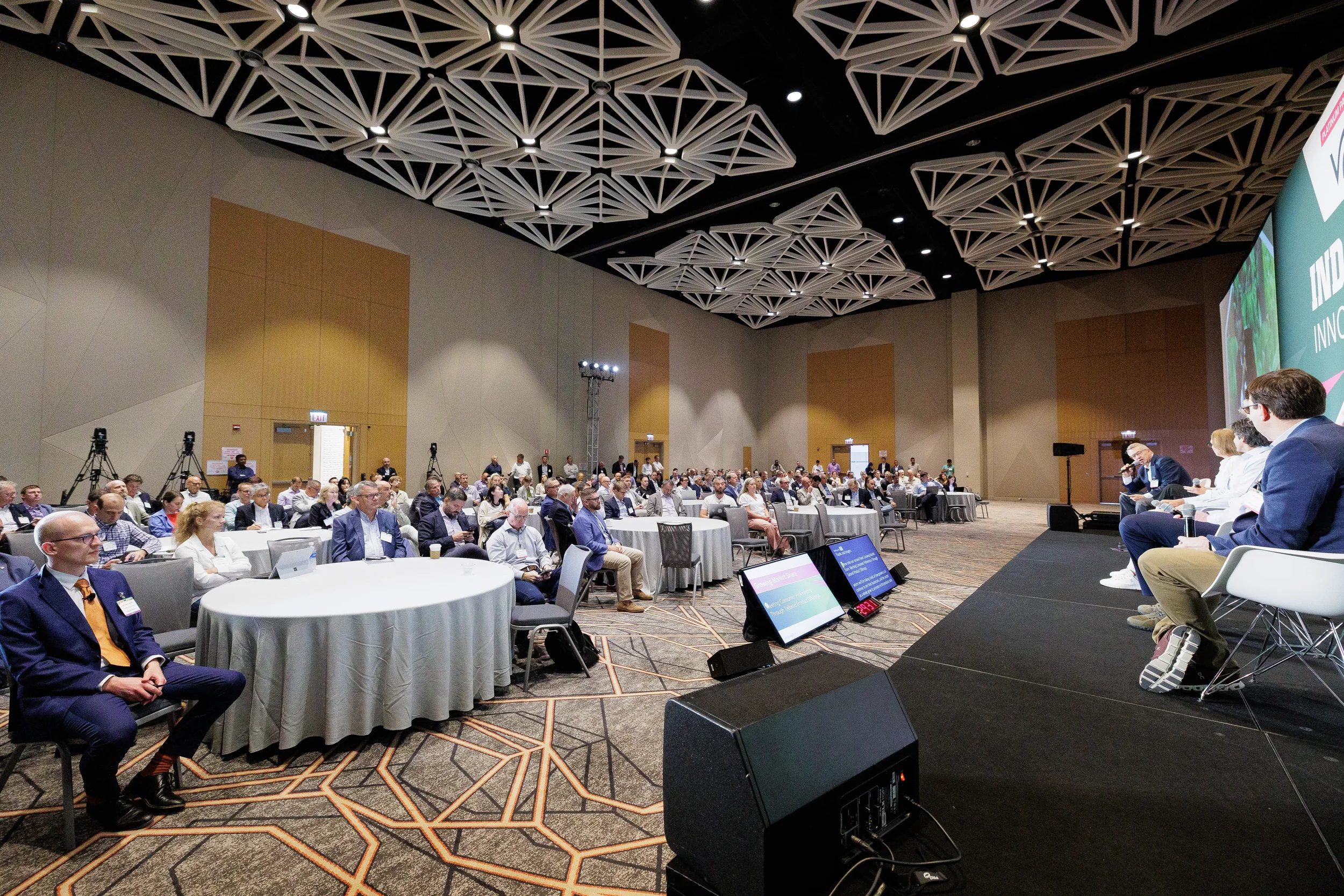 Wide view of seated audience watching panel discussion at Chicago industry conference event