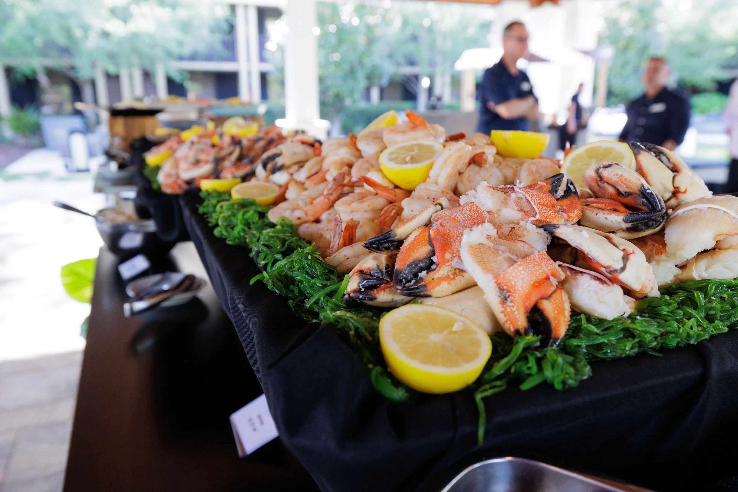 Abundant outdoor seafood display with crab claws, shrimp, and lemon at Chicago corporate event reception