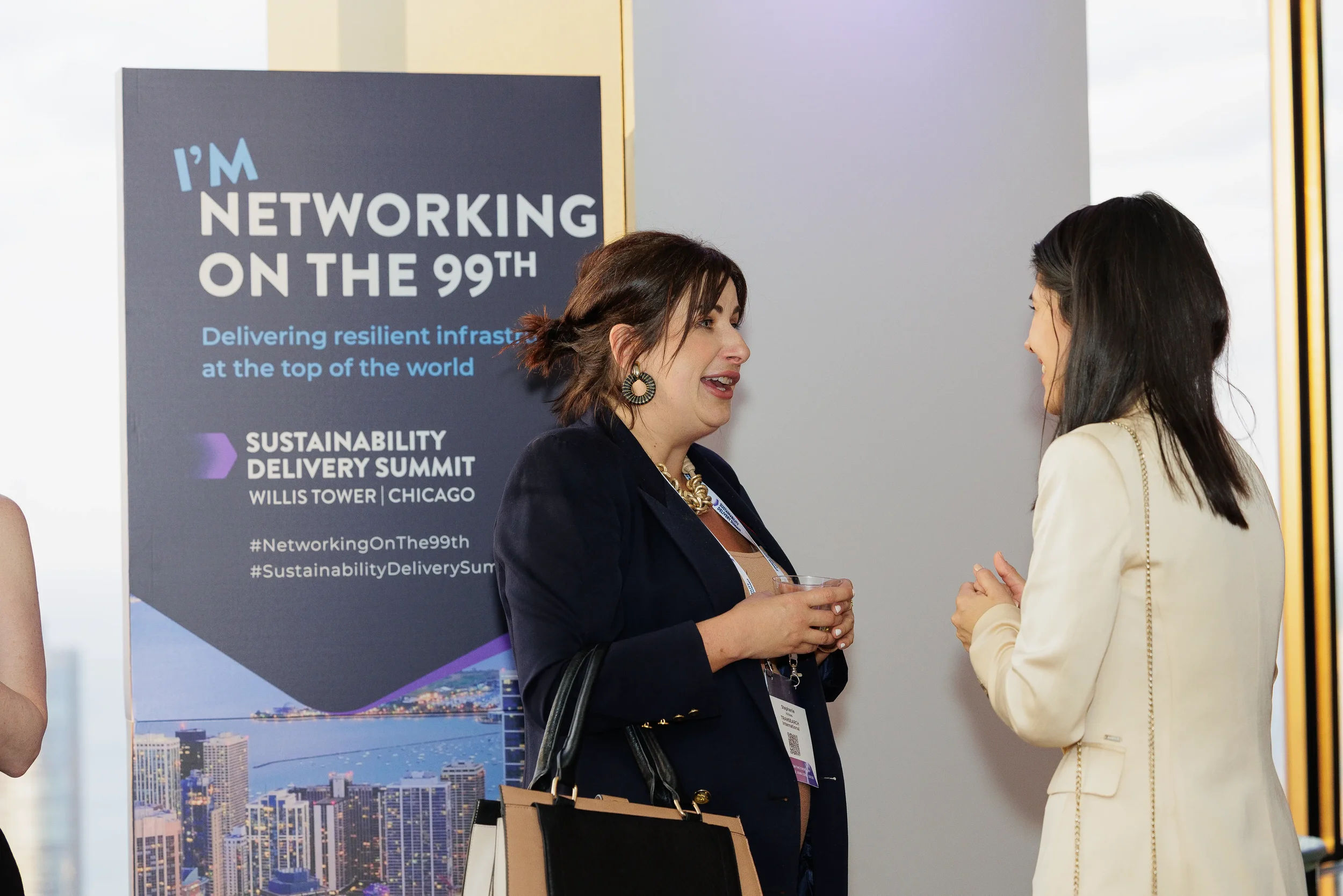 Attendees engage in conversation while holding drinks at Orlando corporate event reception