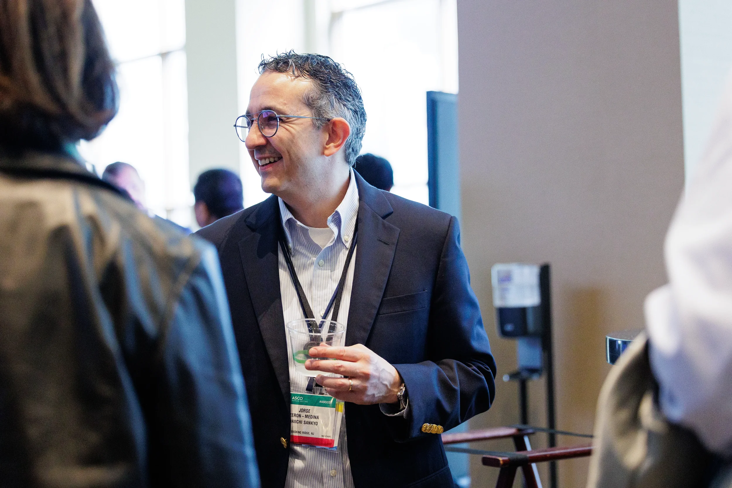 Attendee smiles while conversing at Chicago corporate conference reception
