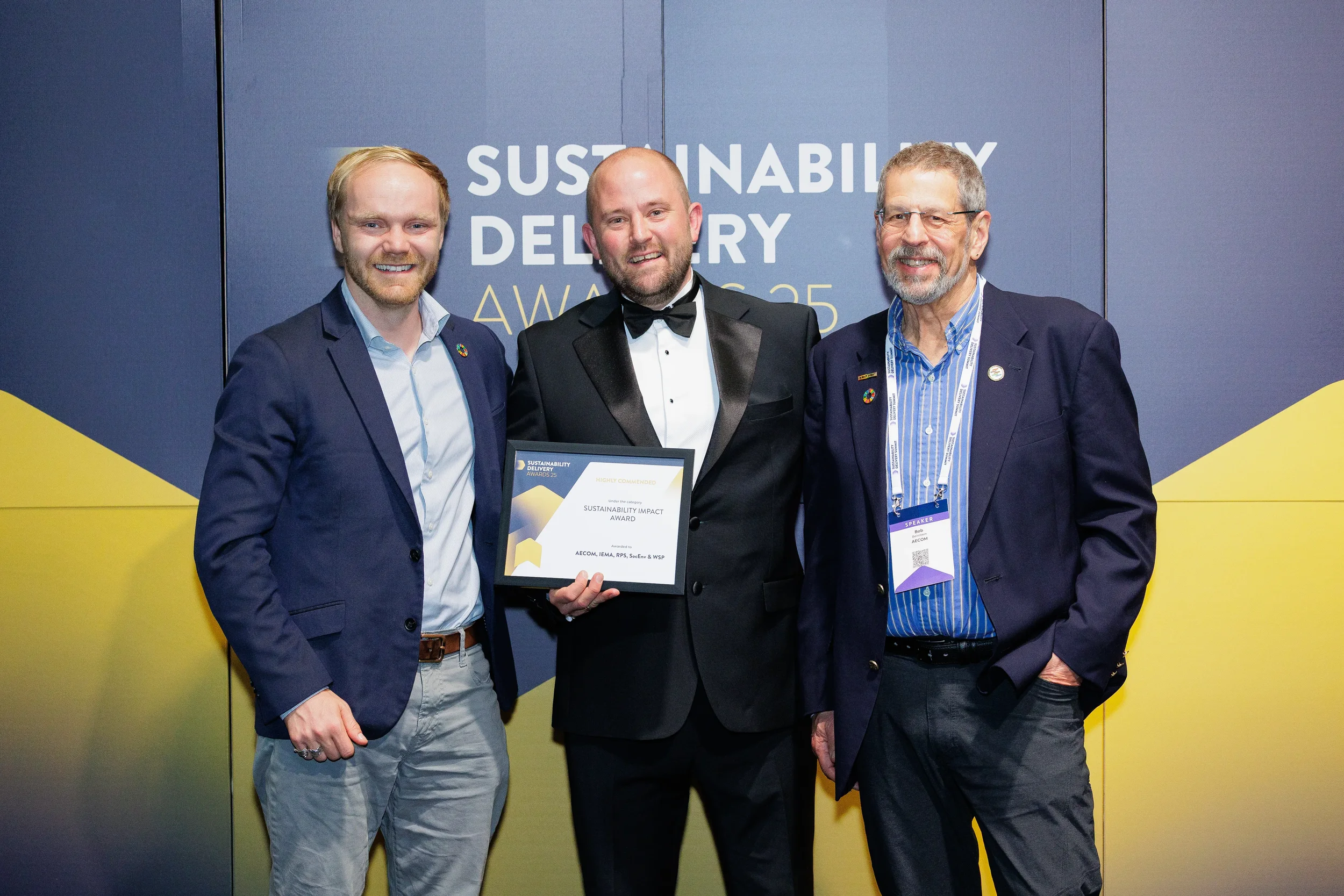 Award recipients pose with certificate in formal attire at Orlando corporate conference awards ceremony