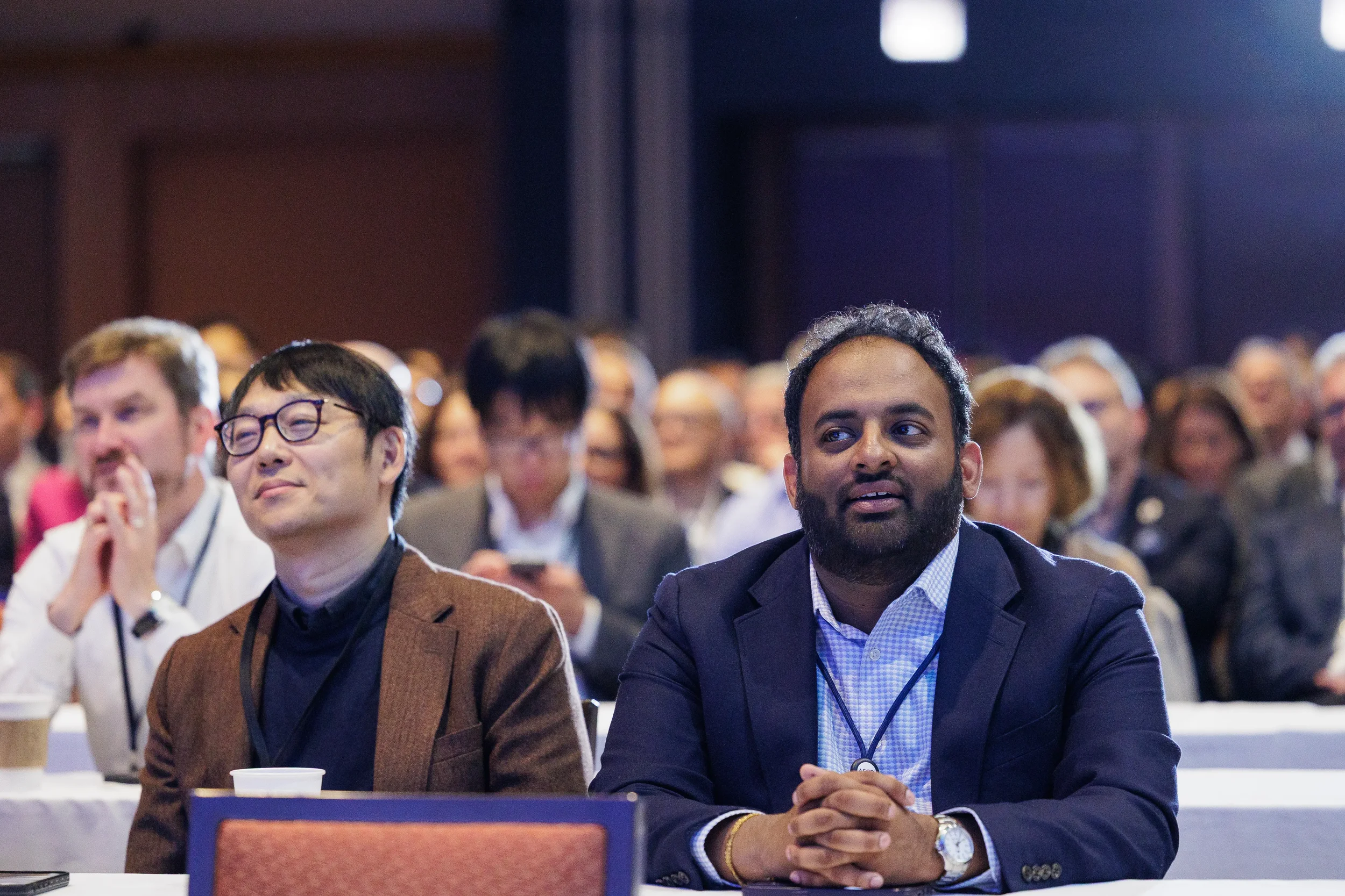 Attendees seated in audience during general session at Orlando corporate conference