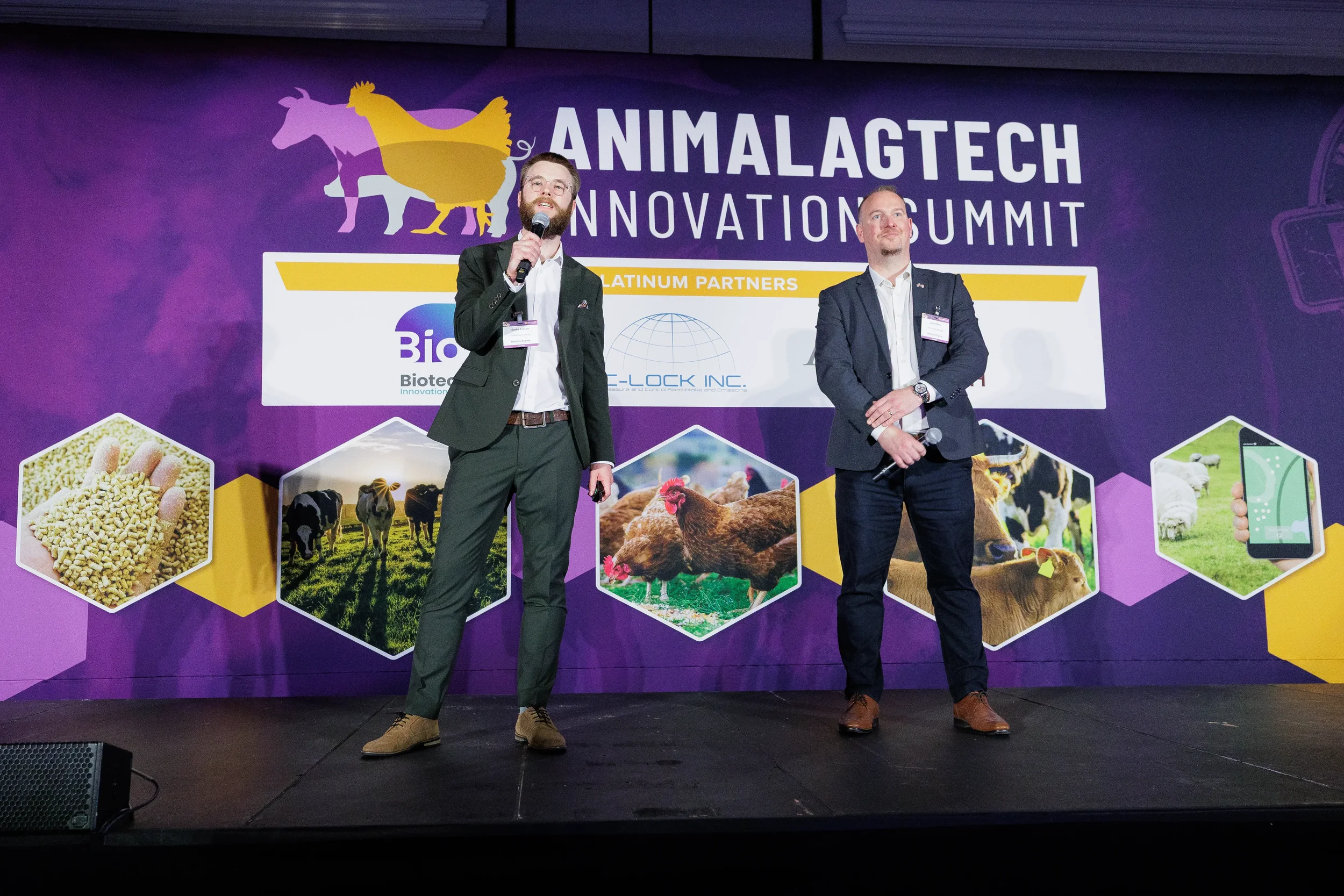 Two speakers present together on branded stage at Chicago industry summit