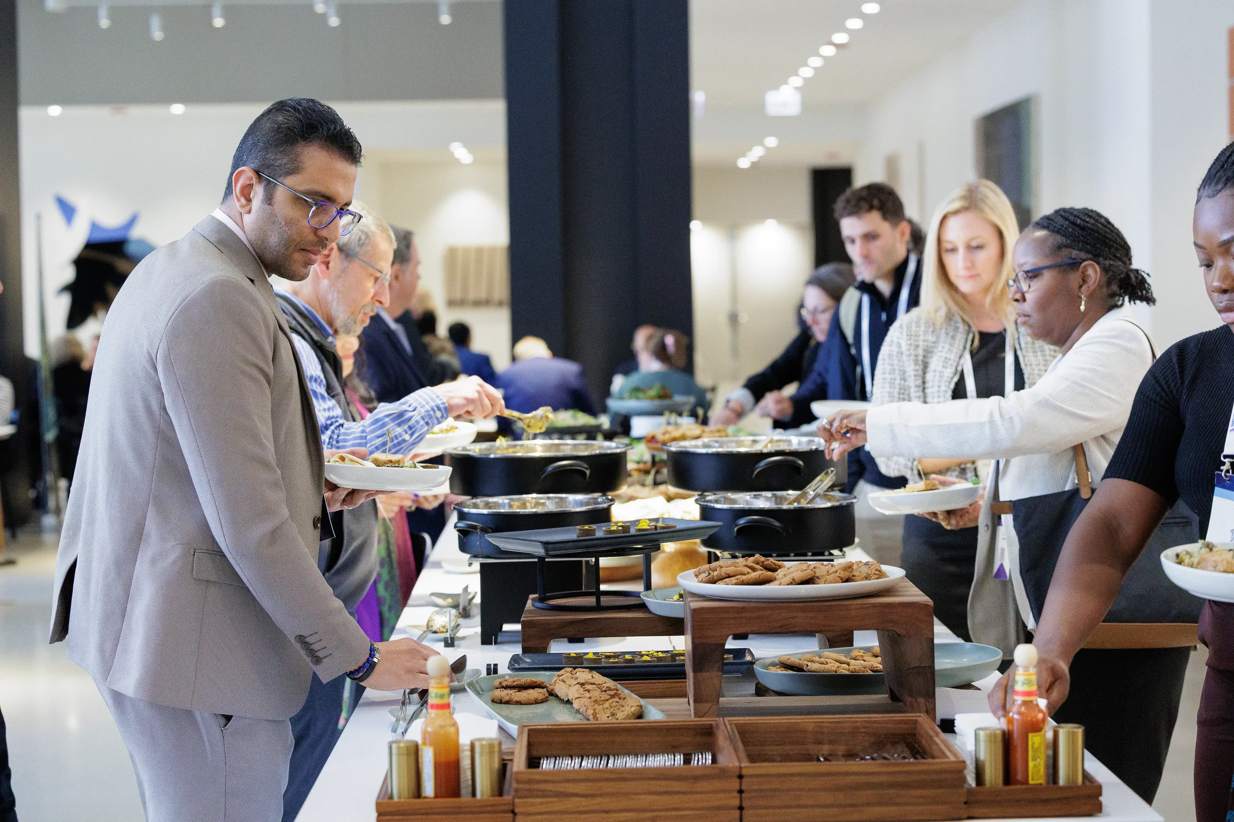 Attendees serve themselves from buffet line during Orlando corporate event catering break