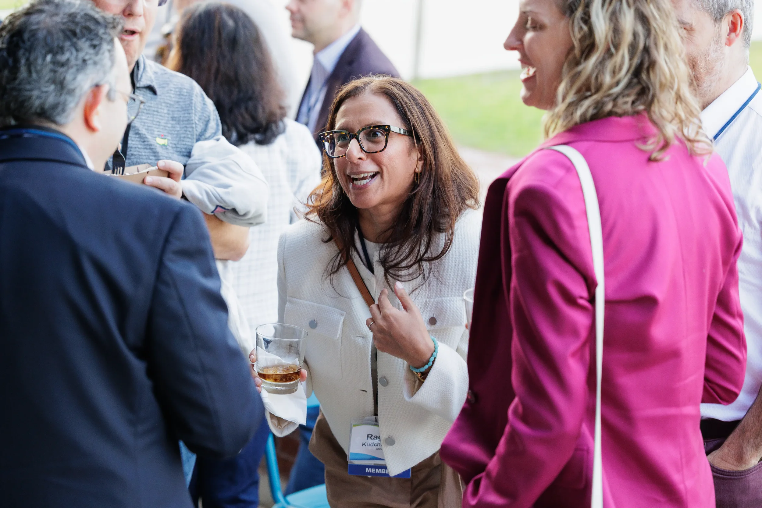 Attendees share a laugh during conversation at outdoor Orlando industry reception