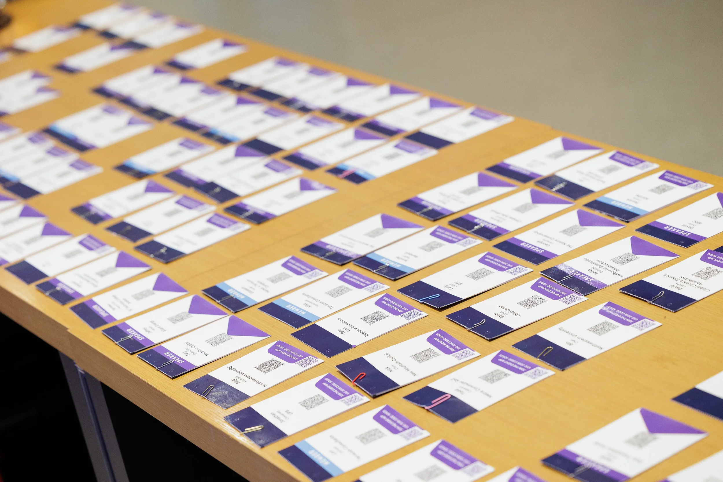 Rows of speaker badges laid out on table at Orlando industry conference registration