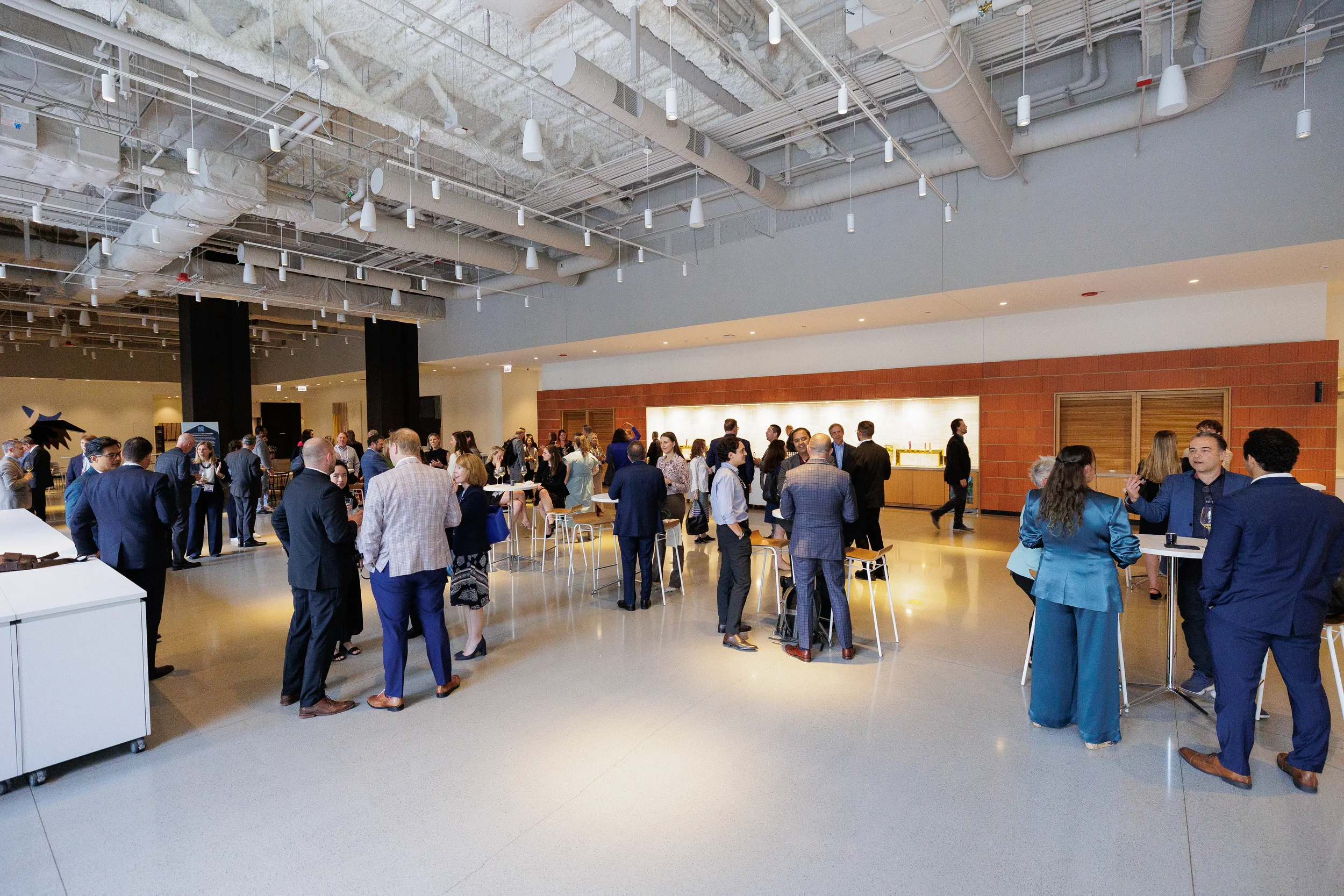 Wide view of attendees networking during reception at Orlando industry conference event