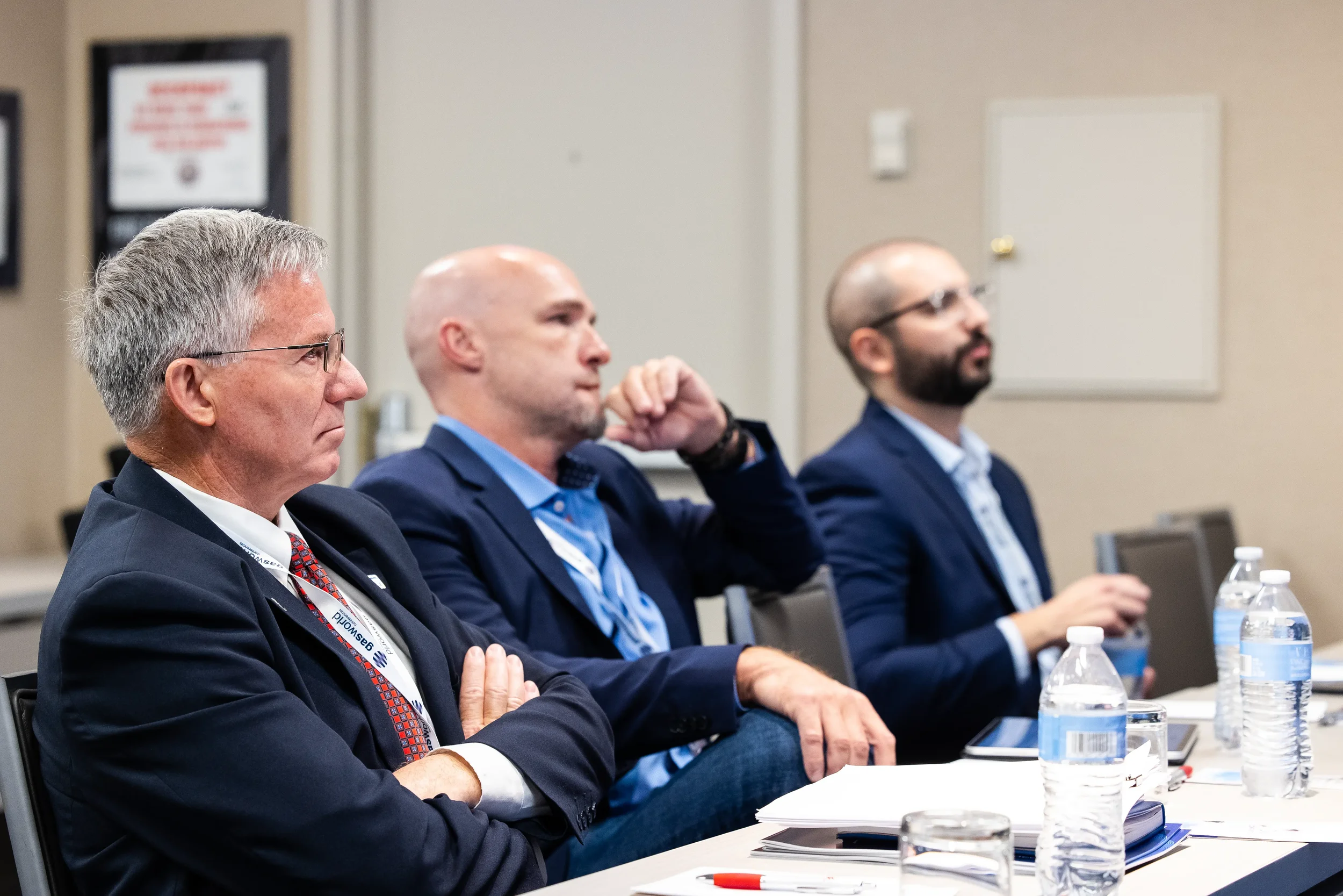 Three conference attendees listen attentively during breakout session at Orlando corporate event