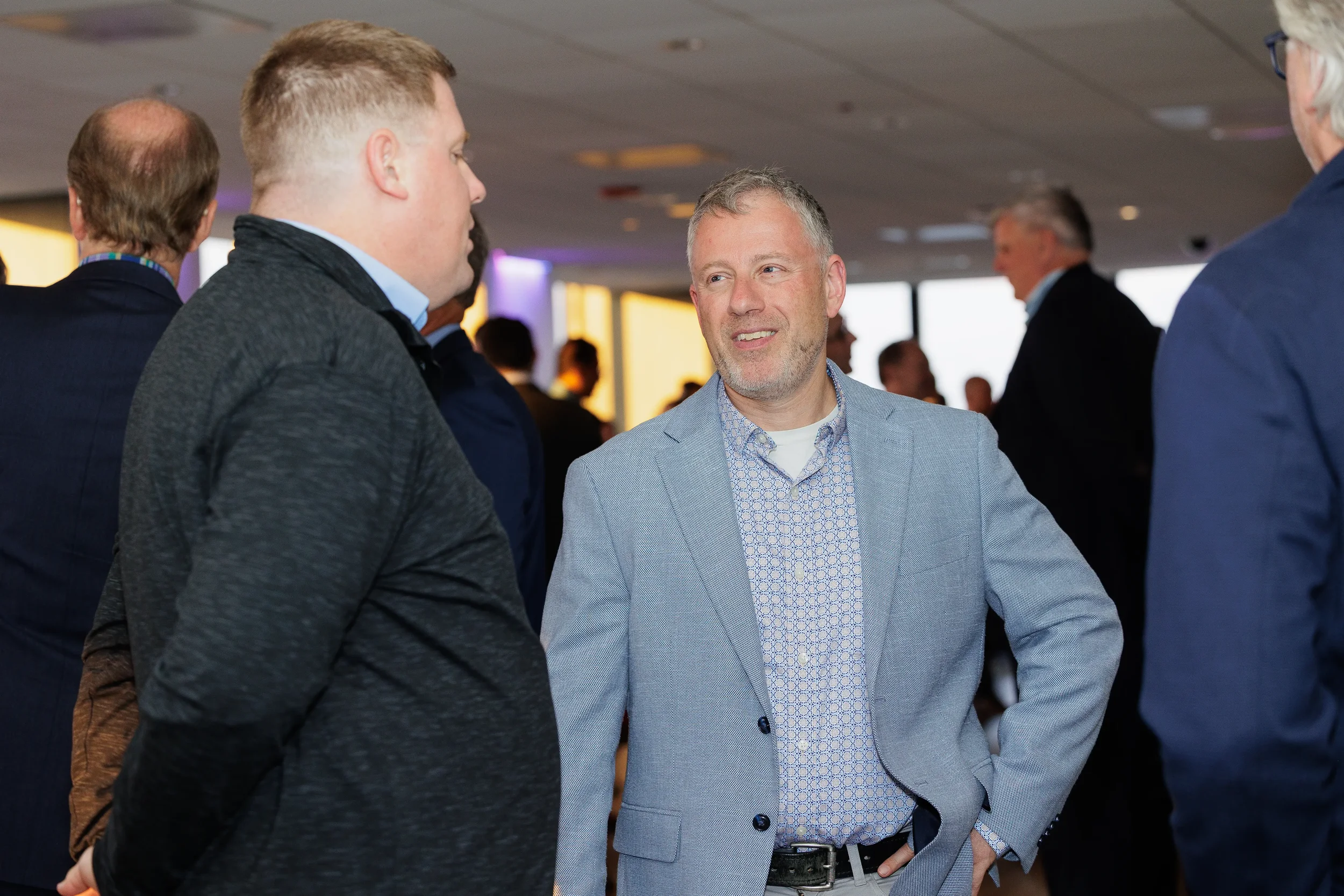 Attendees smile during conversation at evening reception during Orlando corporate conference