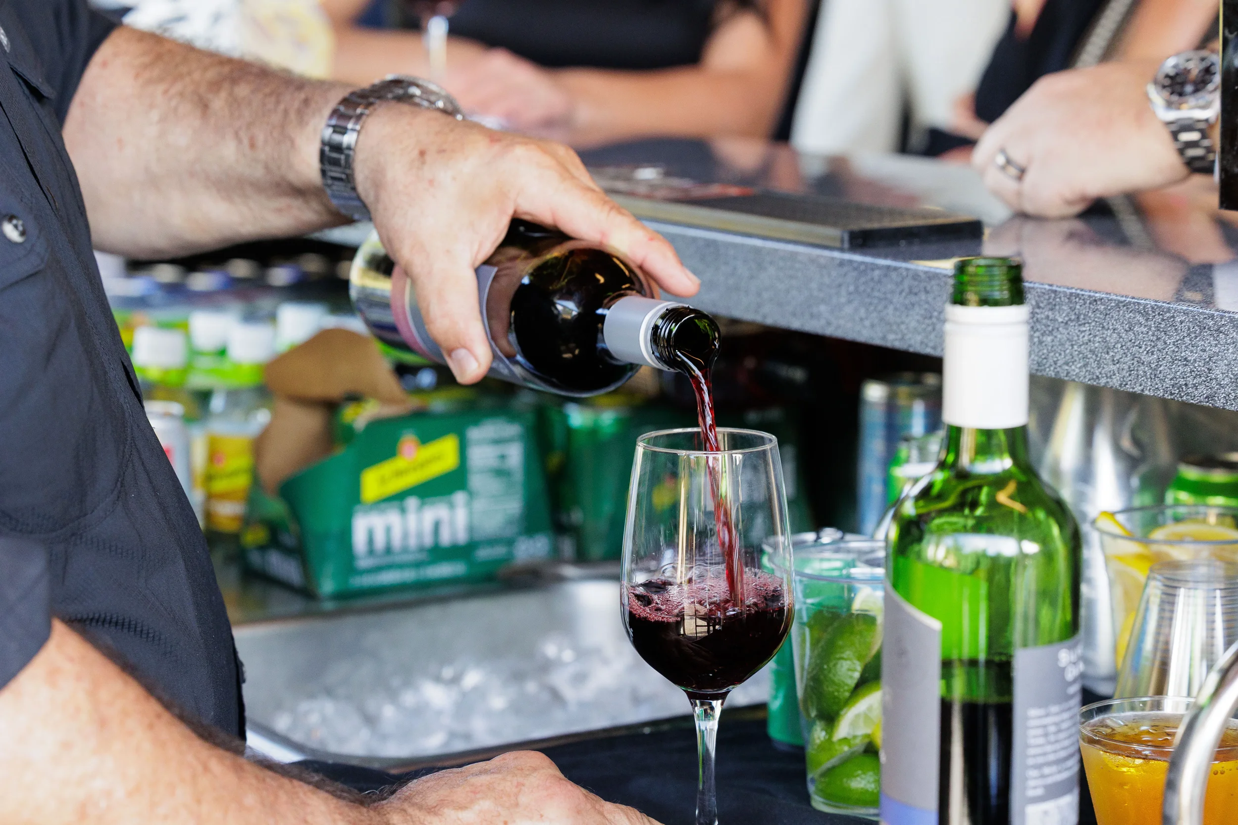 Bartender pours red wine at outdoor bar during Chicago corporate networking event reception
