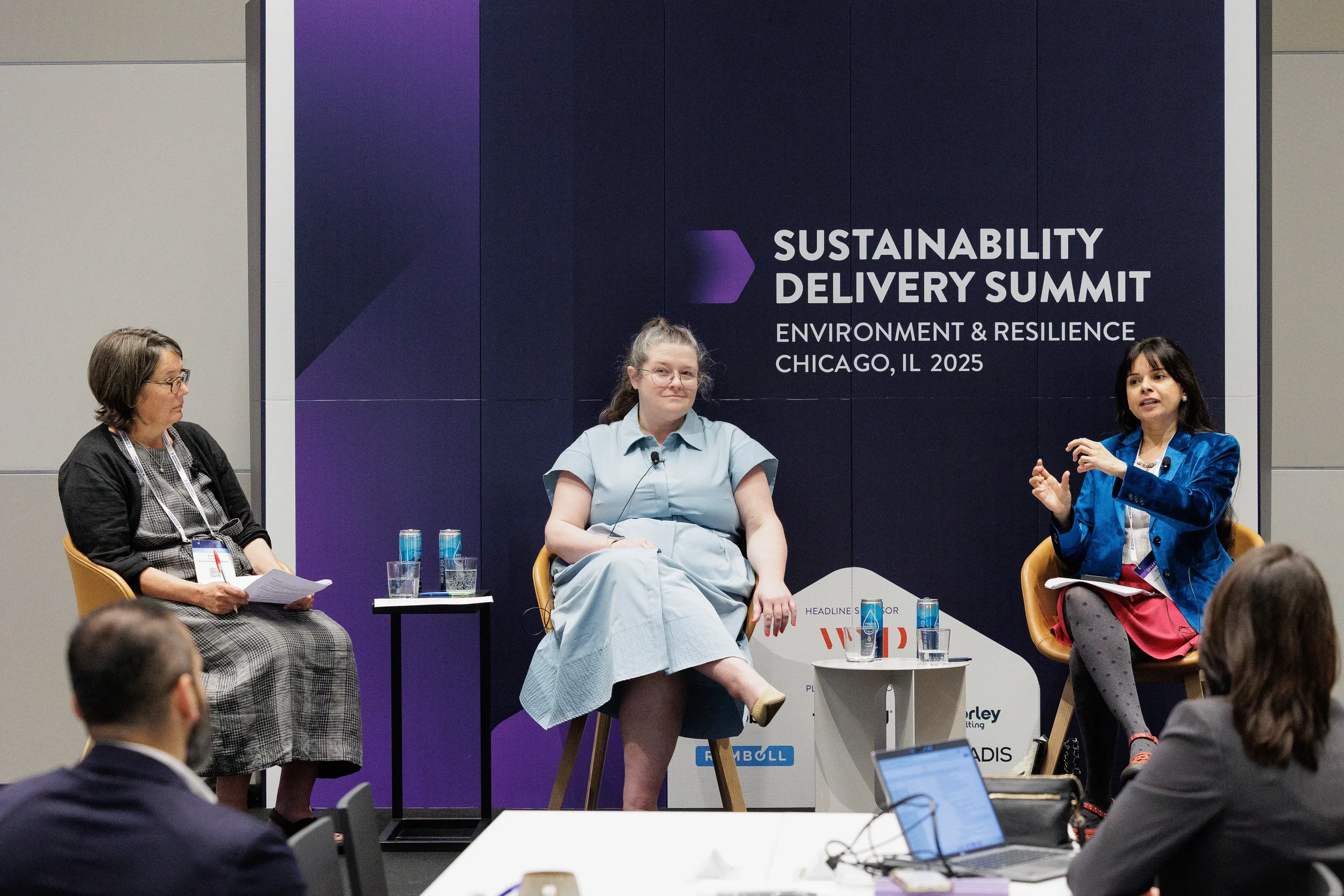Three panelists engage in seated discussion on stage during Orlando industry conference session