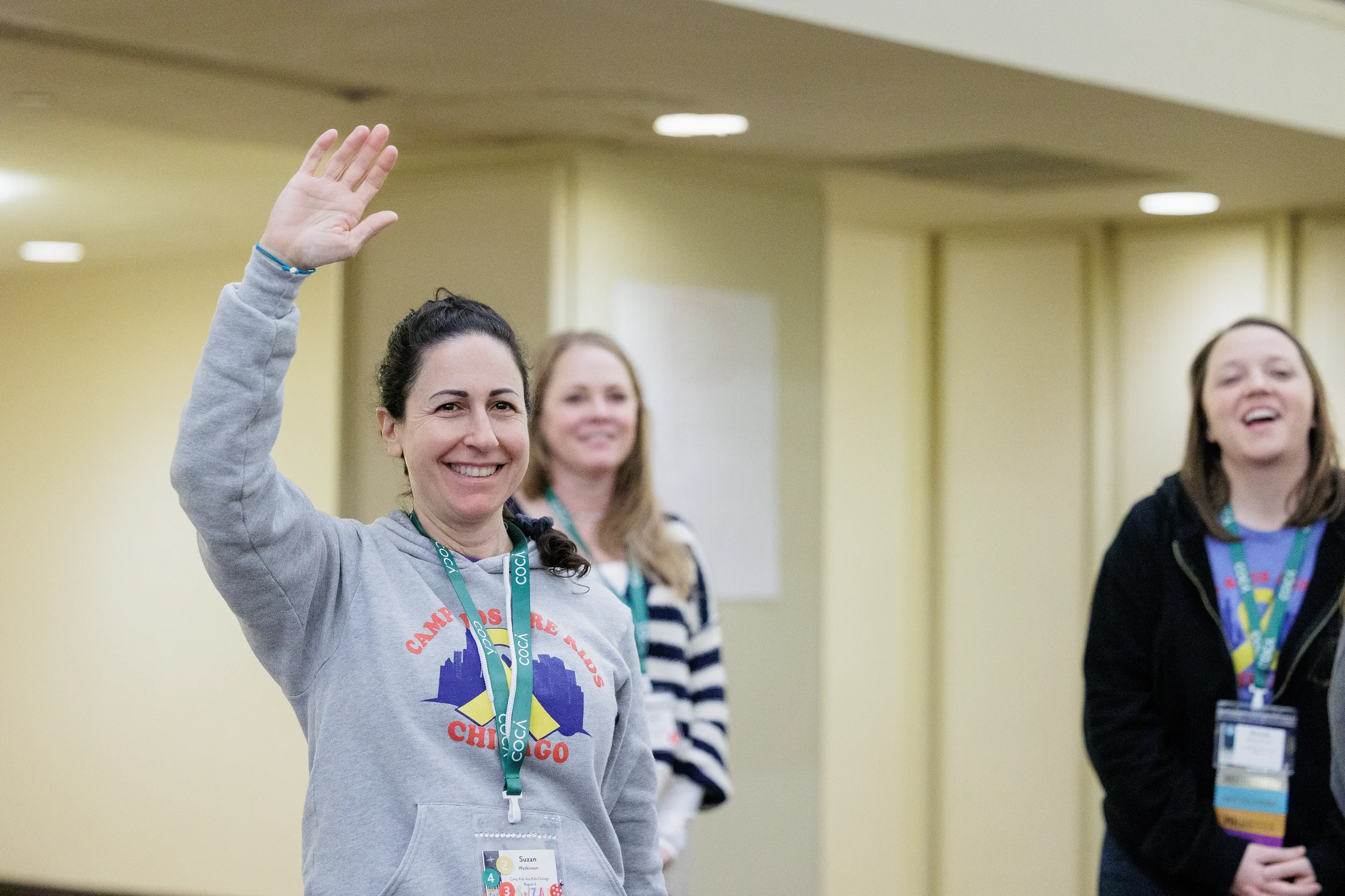 Attendee raises hand to participate during break out at Orlando conference event