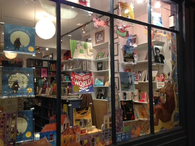 Moonlight Bear curled up with a book