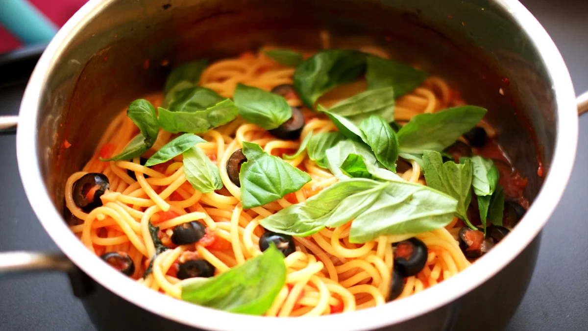 Basil and Olive One-pot Pasta Prep time: 5 mins Cook time: 15 mins Total time: 20 mins Serves: 4 Ingredients: · 250g of Pasta (I used Spaghetti) · 1/2 cup of Black Olives (pitted and sliced) · 1/2 cup Basil (packed) · 2 cups Water · 1 can (14.5oz) Diced Tomatoes · 3-4 cloves Garlic · 2 tablespoons Sugar · 2 teaspoons Salt Instructions: 1) Blend the can of diced tomatoes and garlic together in a food processor until the lumpy bits are broken down. 2) In a large pot, pour the 2 cups of water and the blended tomatoes and garlic and let the mixture come to a boil. 3) When the tomato sauce mixture has come to a boil, throw in the pasta. 4) While the pasta is cooking, prepare the black olives by removing the pits (if you bought the ones with the pits still in them) and cutting each into roughly 3-4 slices. 5) Half of the basil will be cooked together with the pasta, while the other half will be used as a garnish when serving. 6) Halfway through the cooking time of the pasta, add the olives and basil in with the pasta and let cook until the pasta is al dente. 7) Just before turning off the fire, season the sauce with the 2 tablespoons of sugar and 2 teaspoons of salt (feel free to tweak to your personal preference). 8) Serve with the remaining basil.