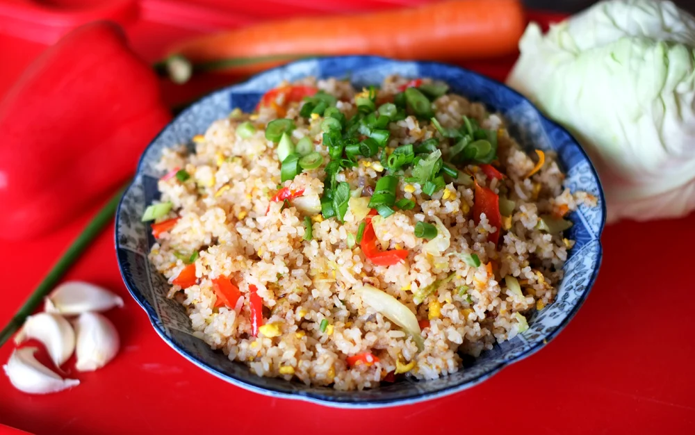 Top Tips for Easy Fried Rice Prep time: 15 mins Cook time: 15 mins Total time: 30 mins Serves: 4 Ingredients: · 3 tablespoons Cooking Oil (Canola, Grapeseed, Coconut, Olive) · 3 cloves of minced Garlic · 1 medium sliced Onion (yellow or red) · 2 cups cooked Jasmine Rice · 1 tablespoon Oyster Sauce · 1 tablespoon Soy Sauce (or any other seasoning of your choice - you may use a salt to taste as well) · 2 teaspoons White Pepper · 2 beaten Eggs · 1 cup each of your choice of veggies (I used cabbage, red pepper, and carrots) · 1 cup choice of Protein (prawns/chicken/fish/beef) Instructions: 1) Prep your ingredients by having the garlic cloves minced, slicing the onion and the other vegetables that you intend to use. I julienned the carrots, sliced the red pepper, and roughly chopped the cabbage. 2) Season the cooked rice by pouring the oyster sauce and white pepper on it (there's no need to mix it up). 3) Heat up a large wok and pour in 2 tablespoons of oil, when the oil is bubbling (this means it is smokin' hot!), tilt the wok to coat the sides evenly and then gently add the garlic and onion. Take note that your fire should be on high heat the entire time, from the time you start cooking to the finish. 4) Sauté the garlic and onions for about 30 seconds, adding in the medley of vegetables and sautéing those further for another minute or two, depending on what vegetables you have used - some take longer to cook than others, do remember to add the ones that take longer to cook first (eg. broccoli, red pepper, long beans). **If you want to use any paste-like seasoning like sambal belacan, tomato paste, tom yum paste, add that in now and combine thoroughly. Next, make a well in the middle of the mountain of veggies and pour the beaten egg mixture in. Scramble the eggs until it cooks through. 5) Time to add the star of the dish in - Add the cooked rice and toss to mix all the ingredients together. Smack and flatten the rice onto the wok and when you hear a slight crackling sound, toss it a couple of times, smack and the rice again until the crackling sound is heard, toss it again - repeat this process until the rice has become dry, the number of times this action will be needed to be executed will depend on the original moisture level of the cooked rice (the wetter the rice is, the more times you will need to do this, the drier, the less). 6) Lastly, before you turn the fire off, season with either salt or a tablespoon of soy sauce, or any other sauces such as tomato sauce, barbecue sauce, chilli sauce, to taste. Throw in a dash of white pepper as well. 7) Serve with some chopped spring onions as garnish and sliced red chillies for a fiery bite. Hope you find this useful and that concludes my Top Tips for Easy Fried Rice post!