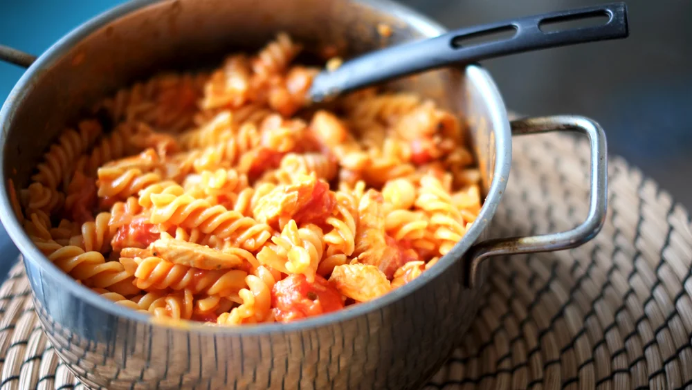 Ccoconut Cream and Tomato Chicken Pasta Prep time: 15 mins Cook time: 20 mins Total time: 35 mins Serves: 4-6 Ingredients: · 300g Chicken Breast, cut into strips · 1 medium Onion, diced · 3 cloves Garlic, minced · 1/2 cup Coconut Cream · 1 can (14.5oz) Diced Tomatoes · 1 can (14.5oz) Tomato Puree · 2 teaspoons Sugar · 400g any type of Pasta · 1/4 cup Pasta Water · 3 tablespoons Olive Oil · 1 knob of Butter Instructions: 1) Start by cooking your pasta until al dente, according to package instructions. While the pasta cooks, prepare the ingredients for the sauce. 2) Season the strips of chicken with some black pepper and salt. 3) In a large skillet, heat up the olive oil and once it starts to sizzle, add the chicken strips in to brown, followed by the onions and garlic. Toss everything around to combine and then throw in the knob of butter. 4) Pour the diced tomatoes and tomato puree in with the chicken and onions, stir to mix well. 5) Your pasta should have completed cooking by well, drain well and reserve 1/4 cup of the pasta water. 6)Stir the pasta water in with the tomato pasta sauce. Let the sauce come to a boil before turning the heat down to let it simmer. 7) Leave the sauce to simmer for 15 minutes, after which pour in the coconut cream and combine well. 8) Let the sauce cook for another 3-5 minutes, season with some sugar, salt and black pepper. 9) Turn the heat off and add the cooked pasta in, toss everything well. Serve and enjoy!