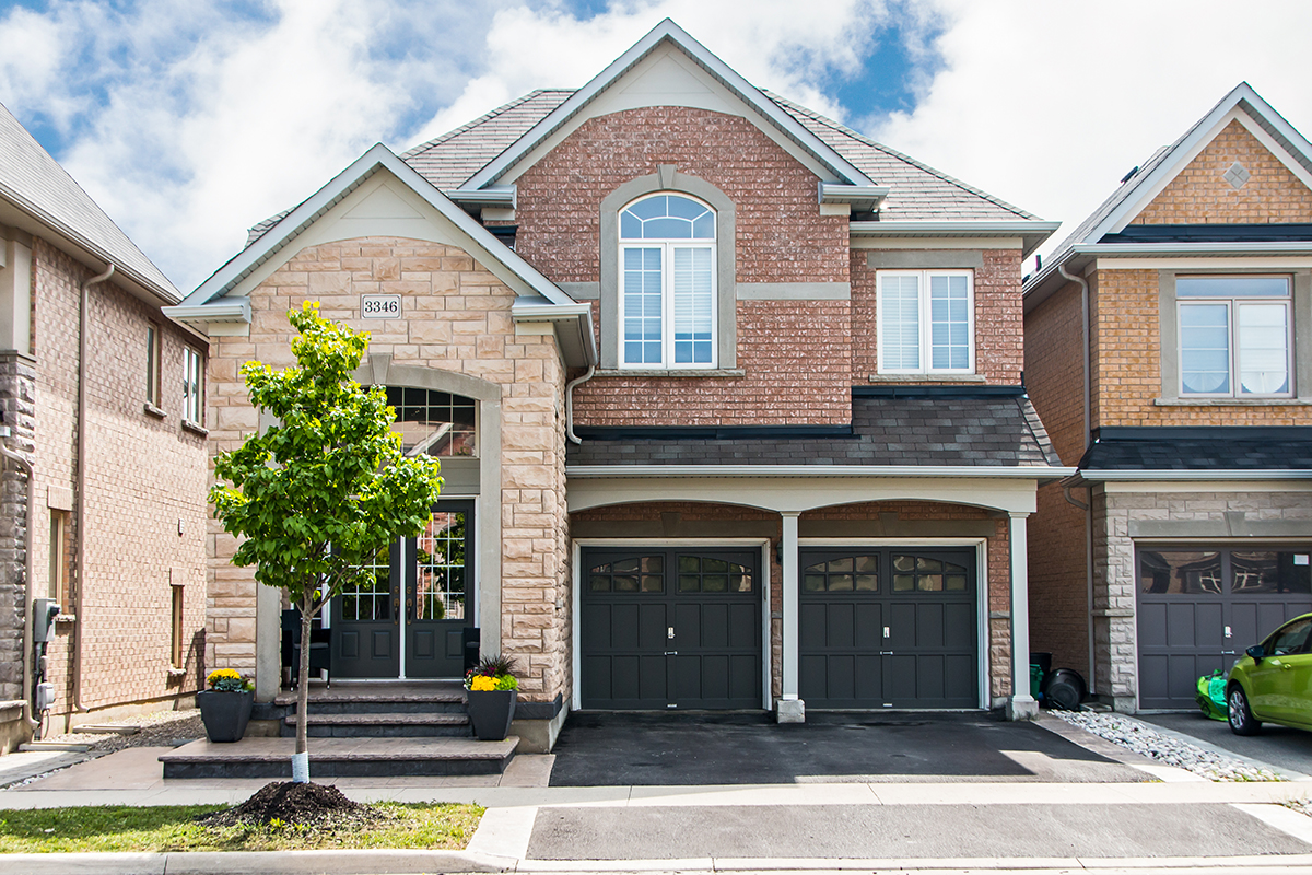 3346 Moses Way - Front view of two door garage & large home