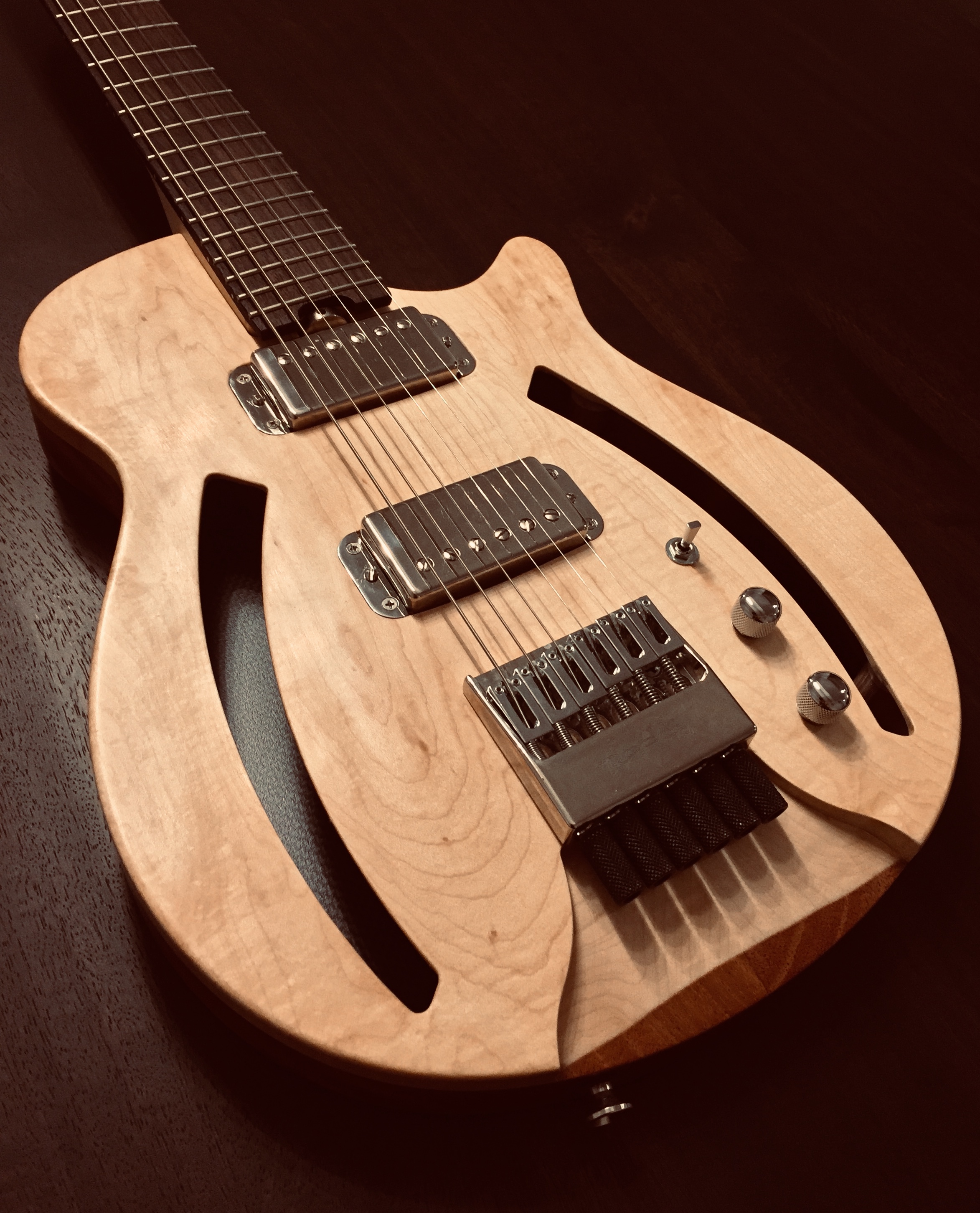 The semi-hollow body is constructed with three different materials: Solid mahogany, solid maple and carbon fiber. The mahogany portion provides warmth and sustain. The maple top accentuates the response and provides note definition.