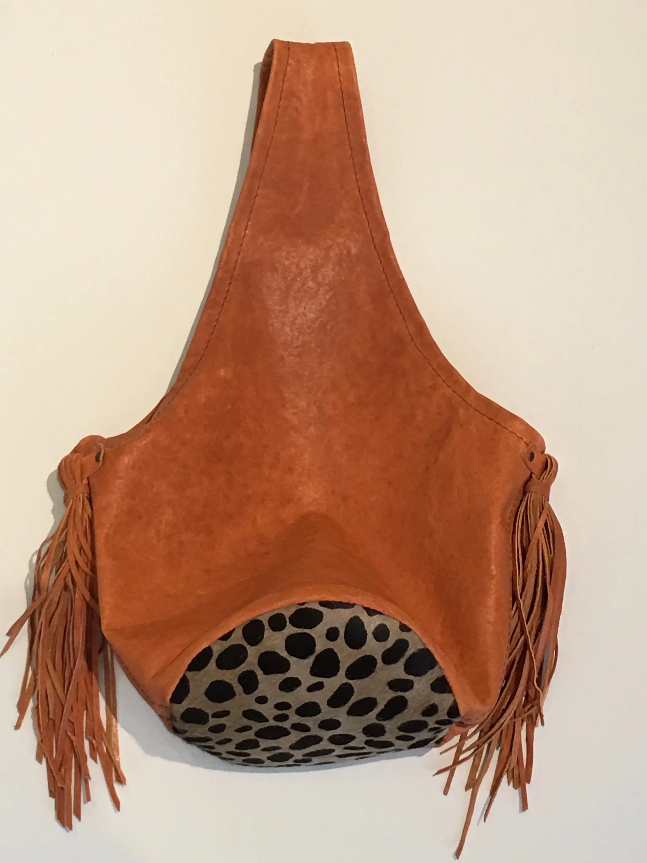 Coral lambskin Bucket Style Bag with hair on hide bottom and long soft lambskin tassels. $275..jpg