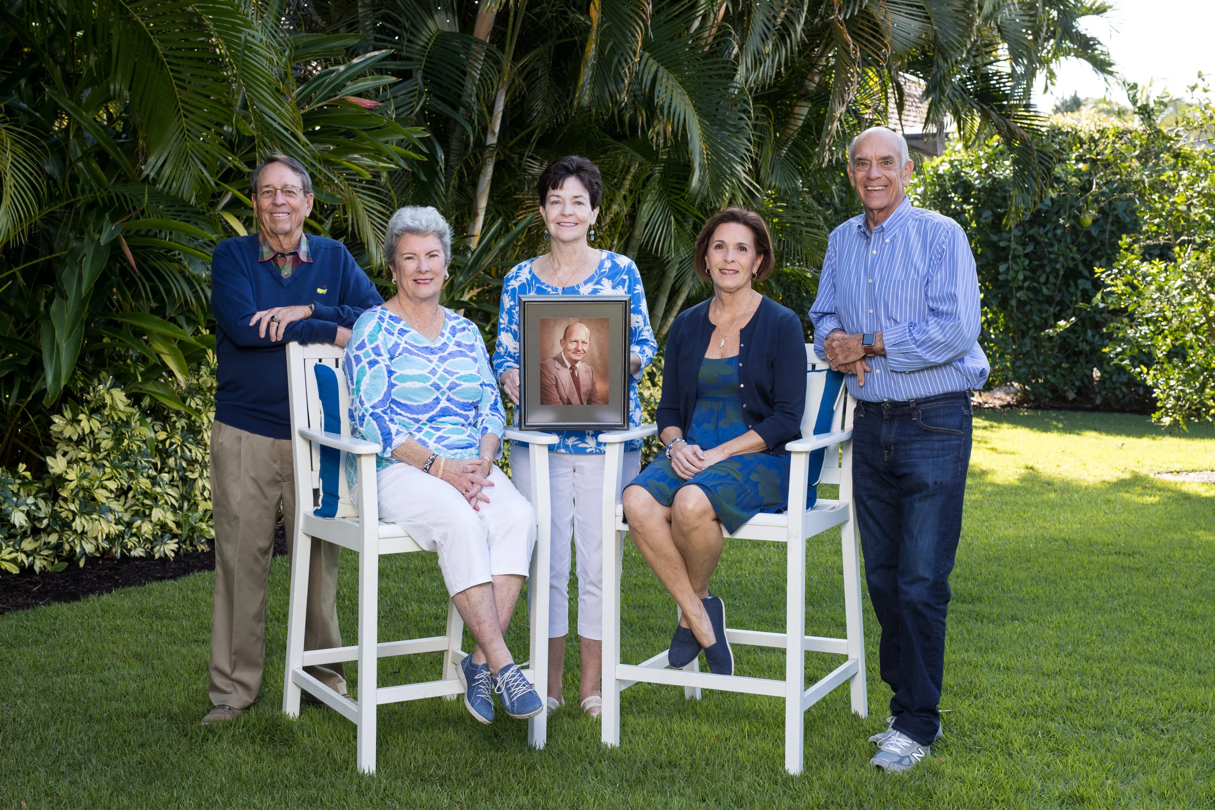 Henry E. Haegg, Jr.'s five stepchildren are carrying on his legacy through donor-advised funds created in their names at the Community Foundation of Collier County. Pictured are Larry Halpin, Cathy Munsell, Kathleen Halpin ( holding picture of stepdad Henry E. Haegg), Molly Eovino, and Jamey Halpin