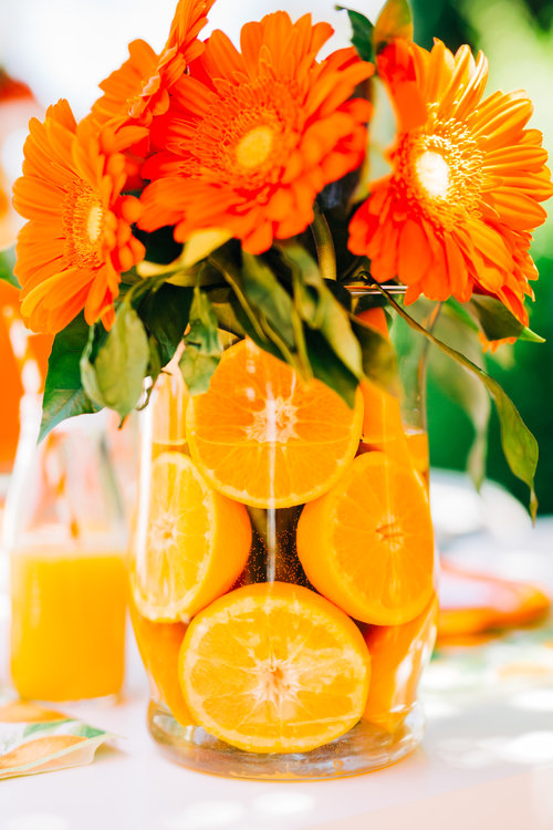fresh sliced orange fruit vase with flowers Little Cutie baby shower decoration ideas. Check out this list of Little Cutie baby shower ideas. Includes ideas for favors, food, decorations and more.