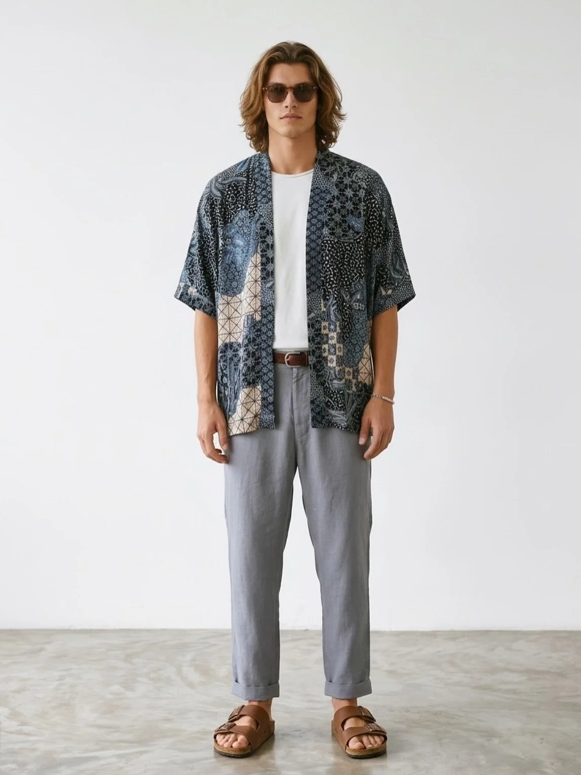 The NIRA kimono shirt is an ode to the endless shades of blue -  the calm of the ocean, the depth of twilight, and the softness of reflected sky. Its intricate pattern blends tones of indigo, sapphire, black, and touches of white, creating a fluid mo