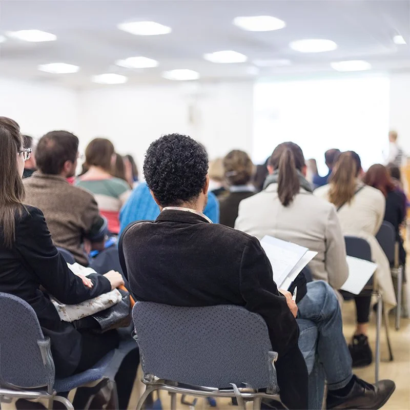 Successful business people learn from an expert giving a speech at a conference