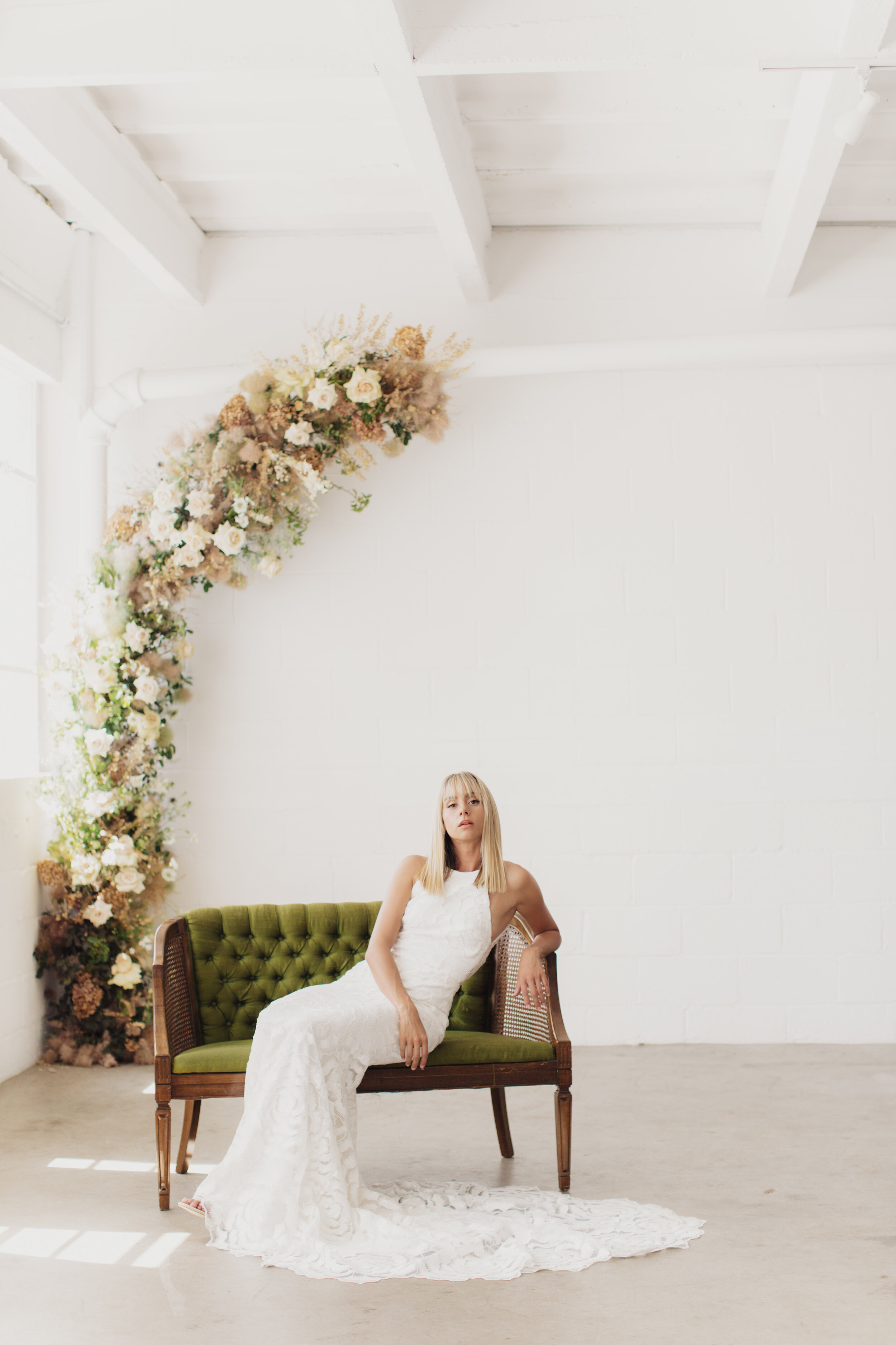 bride sitting on 70's loveseat