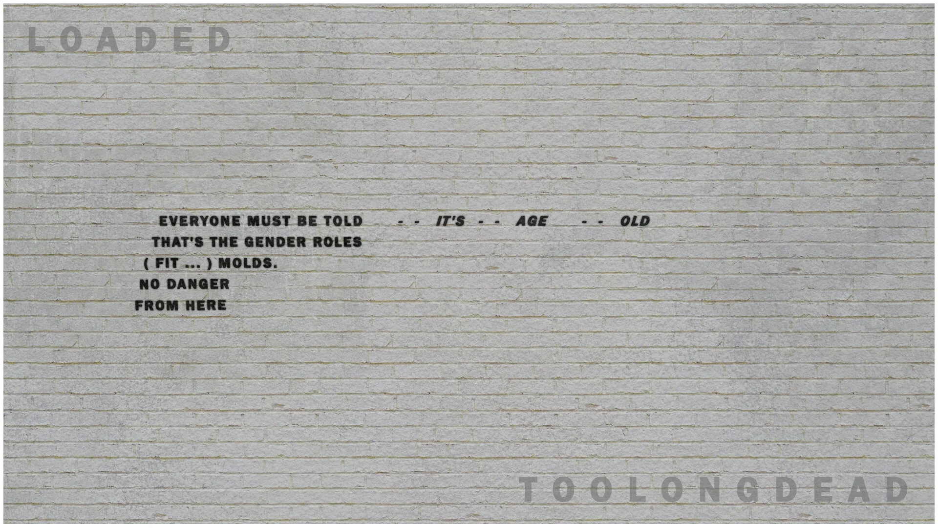 LOADED PISTOL ON A BRICK WALL