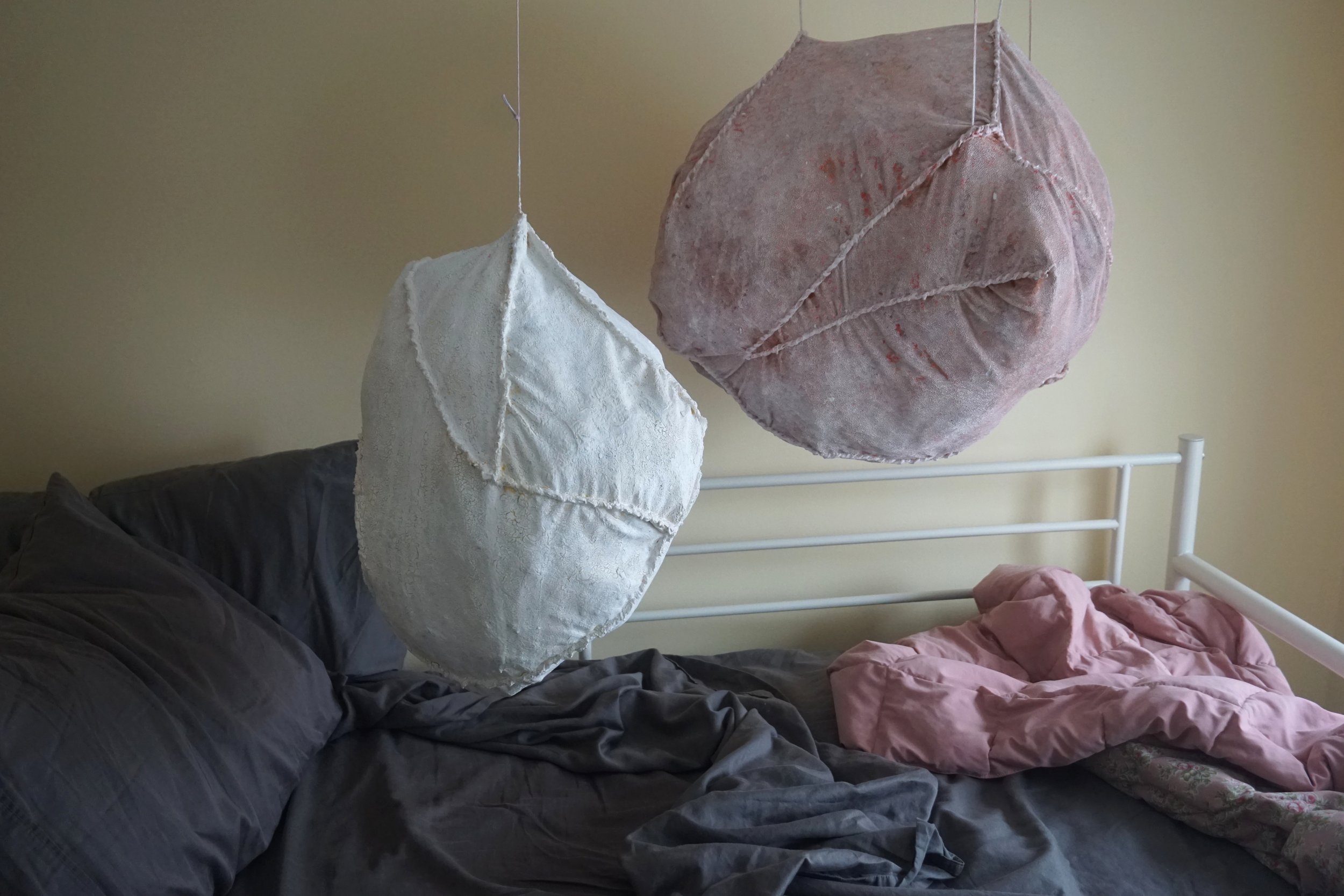  These   Pods   are occupying my bed. Two roughly stitched and encrusted pods,  appear to levitate above my bed. This project taught me how important presentation and documentation of work can be. The environment it is displayed in changes the narrat