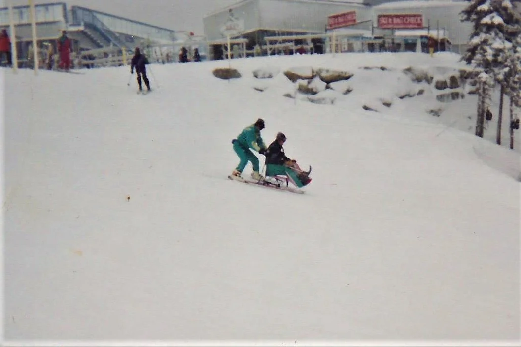 Sit-skiing with a volunteer.