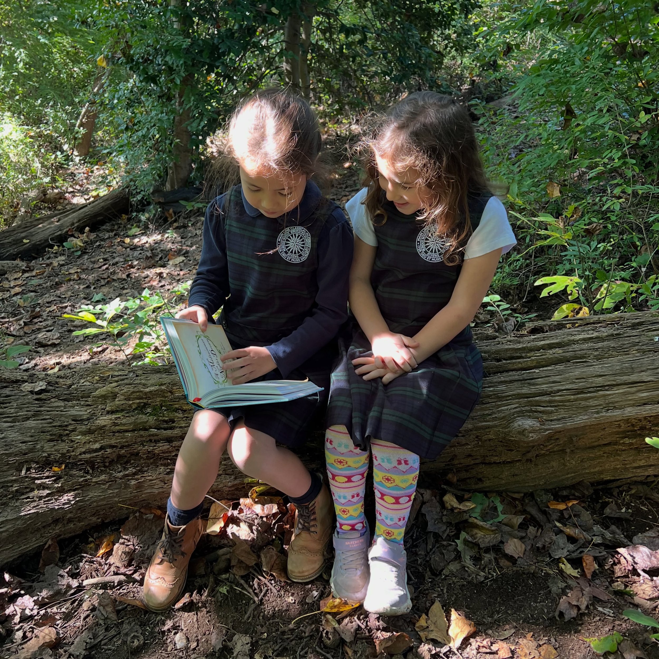 Children are never too young to learn great things&mdash;or to share them with a friend.

During an outdoor class break, these two second graders found a quiet spot on our wooded campus to read a Shakespeare picture book to one another. Their English