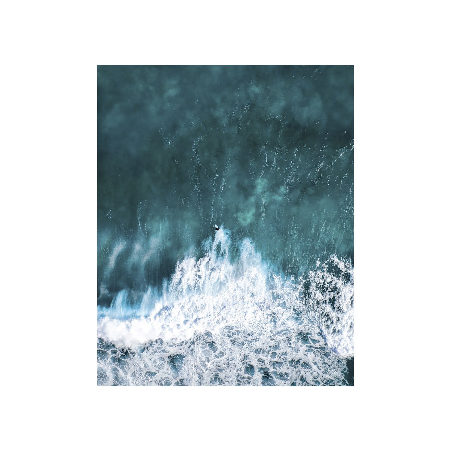 Aerial view of ocean waves and surfer.