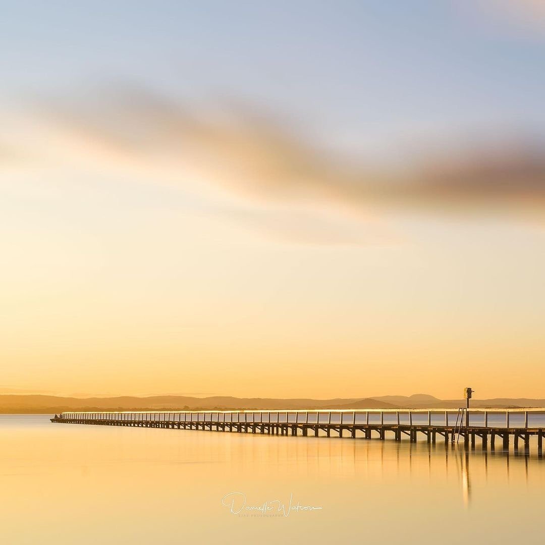 The sun dips lower, casting its golden light across the water, and in this moment, everything feels possible. Standing at the edge of Long Jetty, I feel the worn boards beneath my feet&mdash;years of sunsets etched into them, like reminders of all th