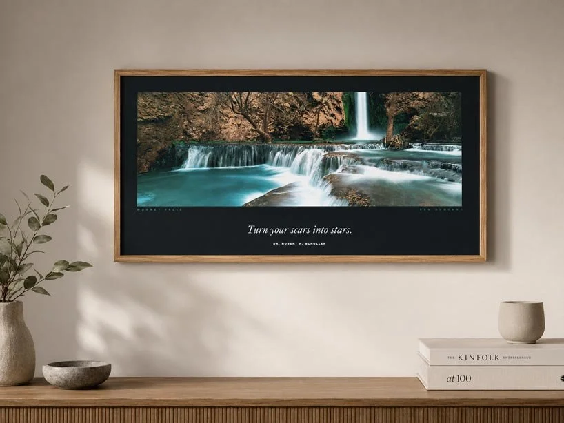 Framed Ken Duncan panoramic print of Mooney Falls above a timber console