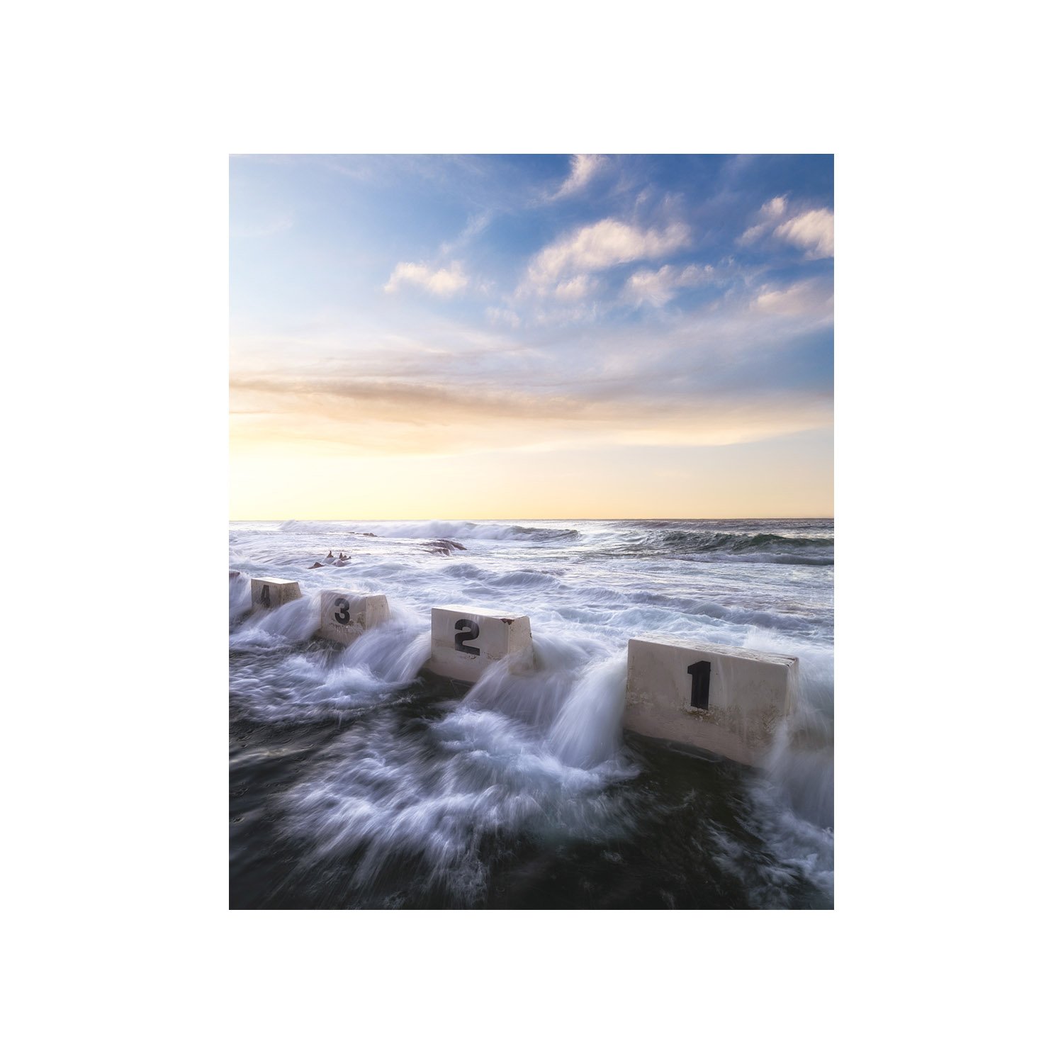 Ocean pool with numbered blocks at sunrise