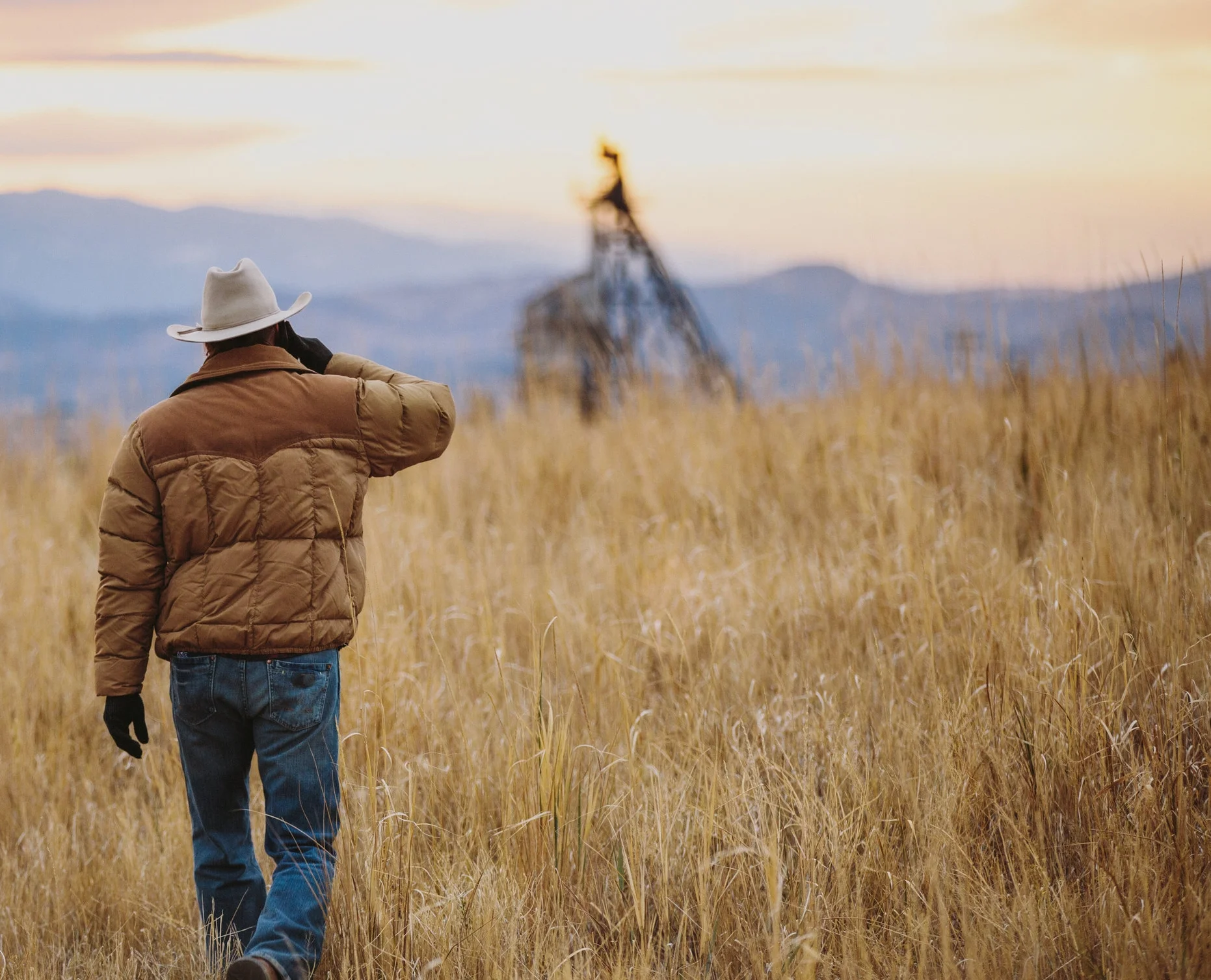Man on phone in tall grass.jpg