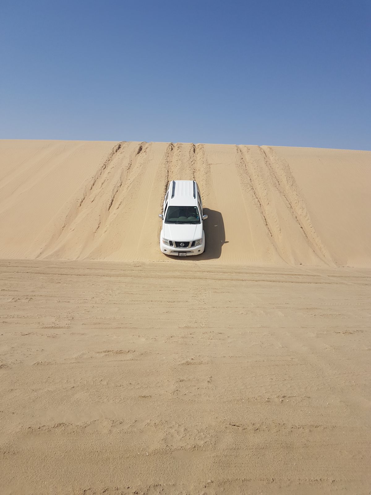 Driving down steep sand slopes