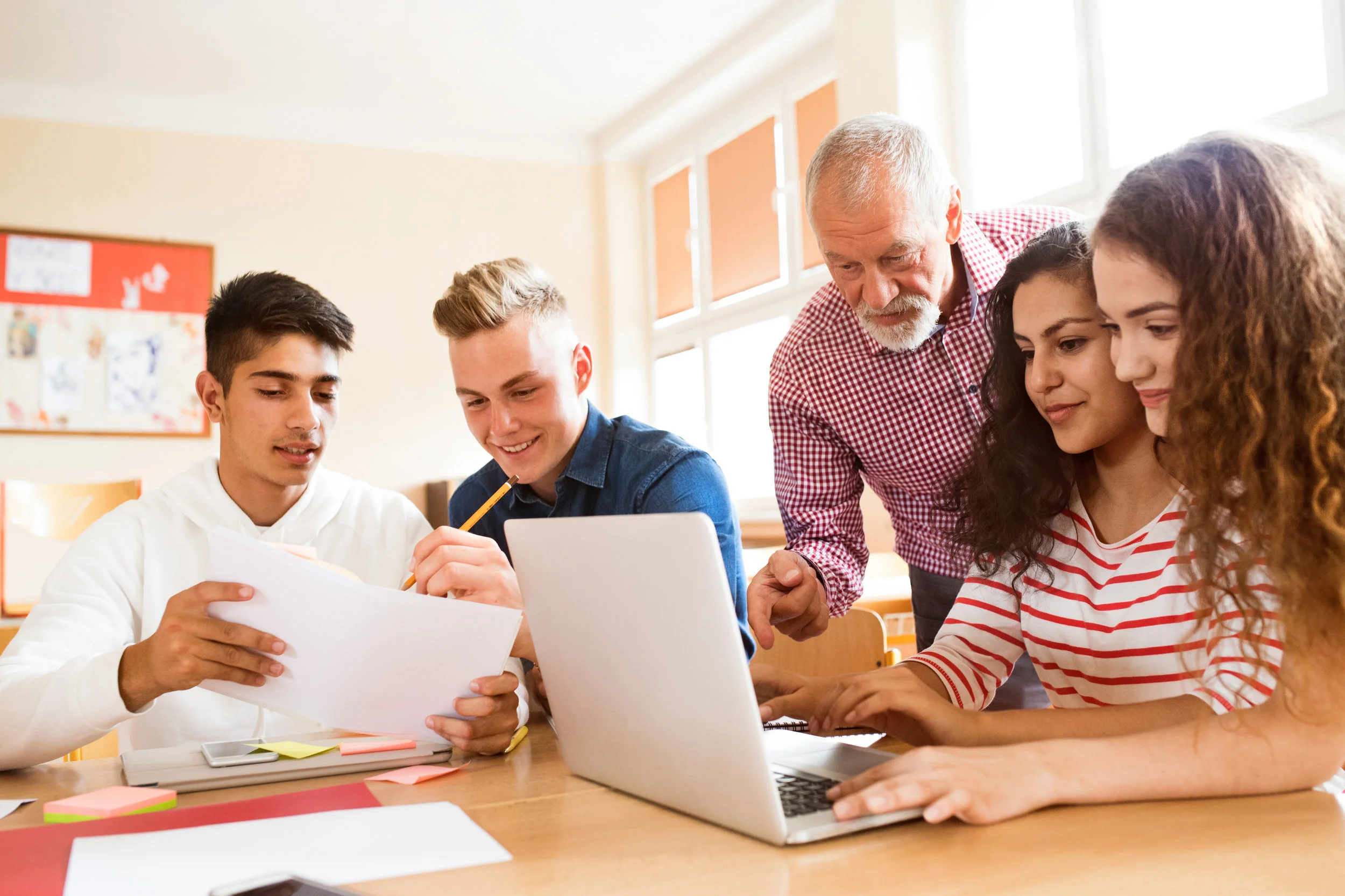 High-school-students-and-teacher-with-laptop.-841551132_5568x3712.jpeg