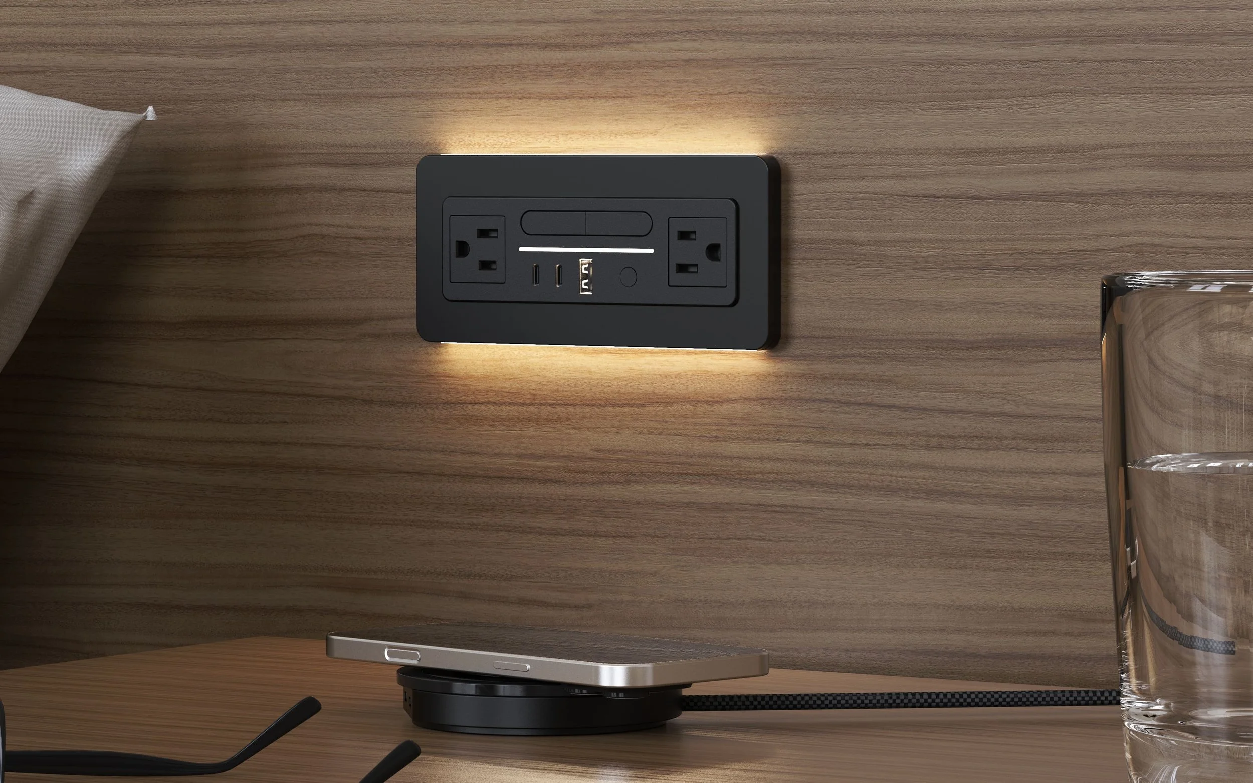 Nonstop Valet Puck wireless phone charger on a hotel nightstand next to Terminal 1 built-in power outlet