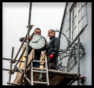 Workmen removing the clock