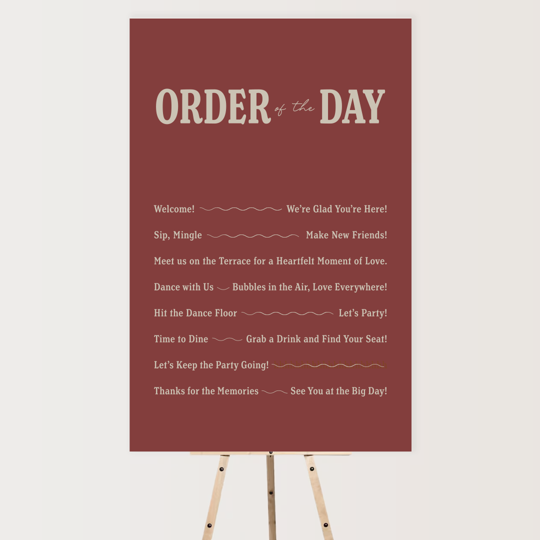 A red bulletin board with a schedule of events titled 'ORDER of the DAY' on a tripod stand. It includes welcome messages, social interaction activities, dance, dining, celebration, and farewell notes.
