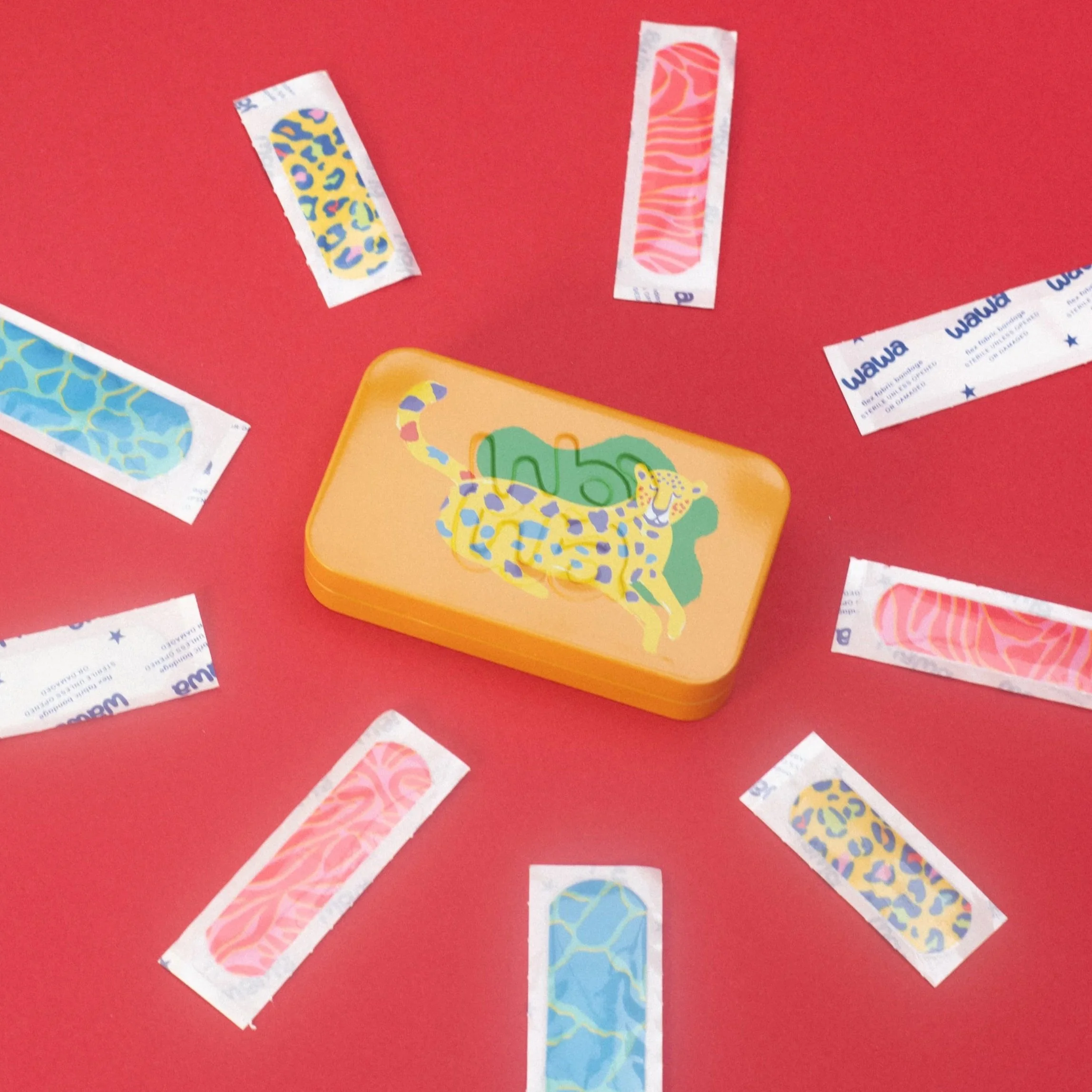 Strips of colorful patterned washi tape on a red background.